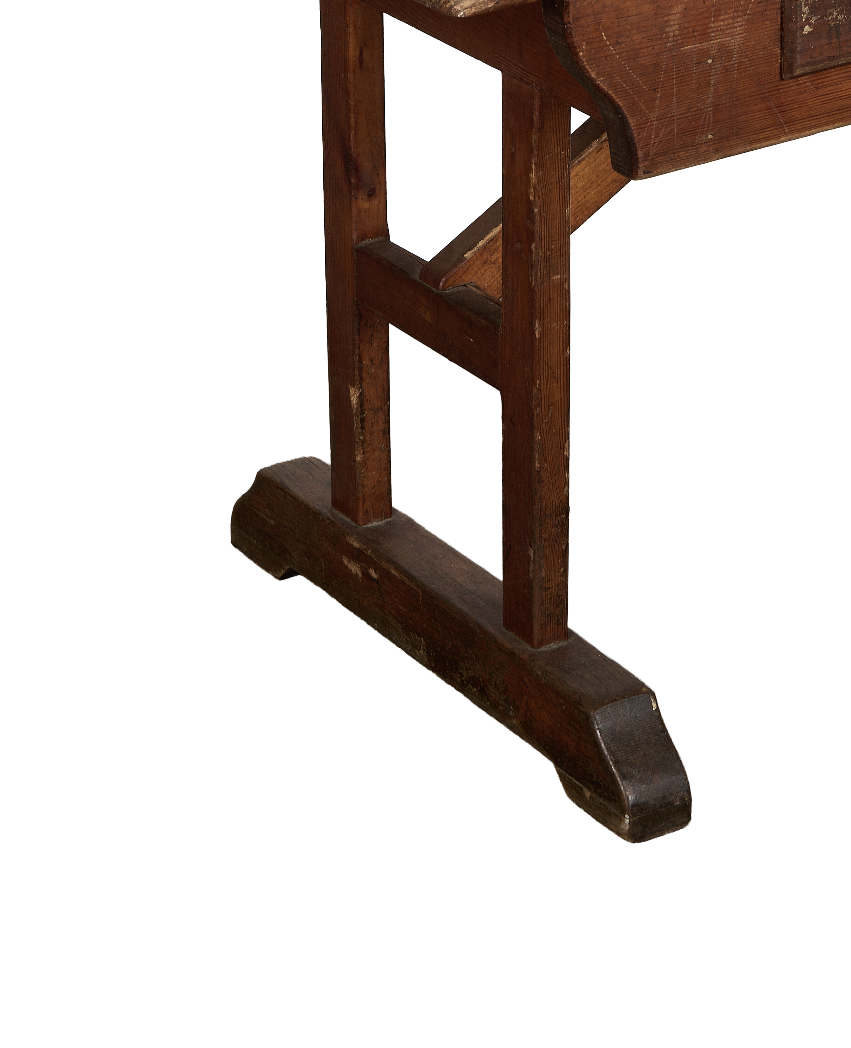 Lower side view of a vintage French oak farm table leg showing aged wood.
