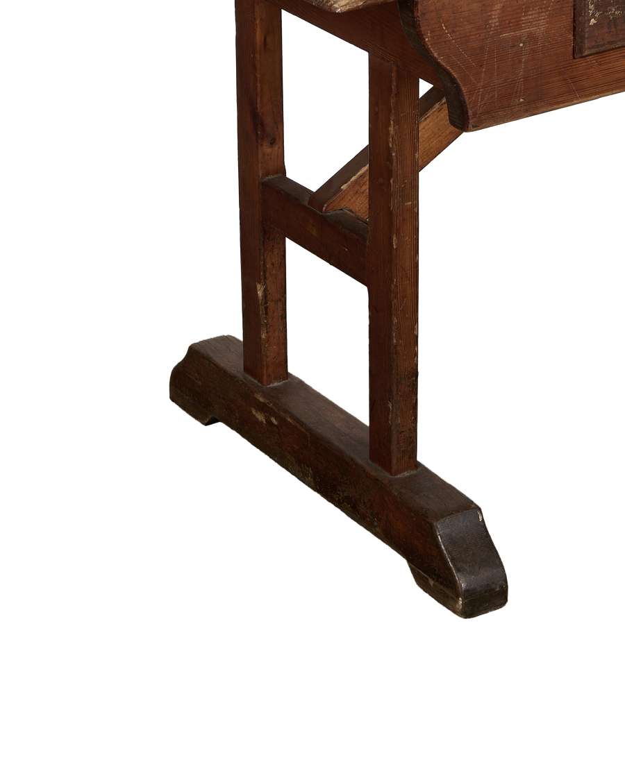 Lower side view of a vintage French oak farm table leg showing aged wood.