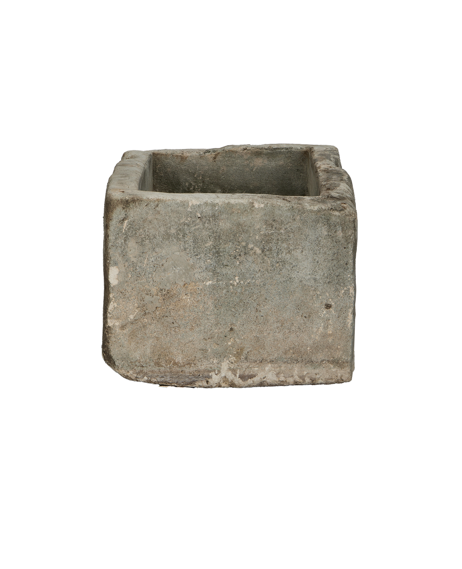 Vintage rectangular limestone trough, front-facing view showing weathered texture and natural imperfections.