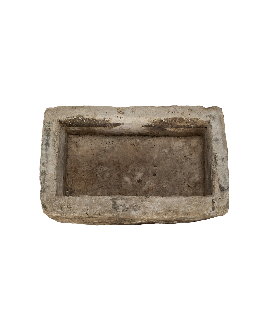 Vintage rectangular limestone trough, showing the weathered texture of its interior.