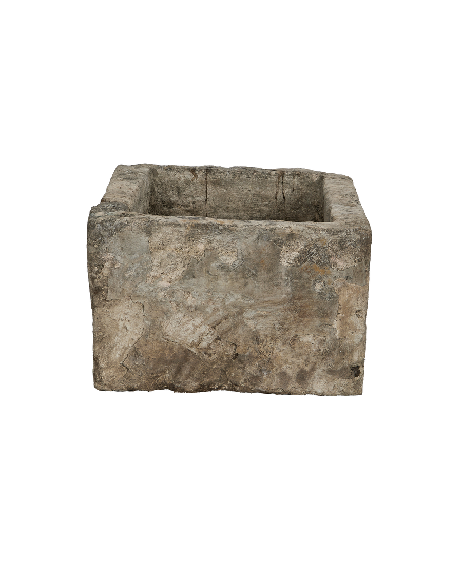Vintage Indonesian limestone trough viewed slightly from above, highlighting distressed texture.