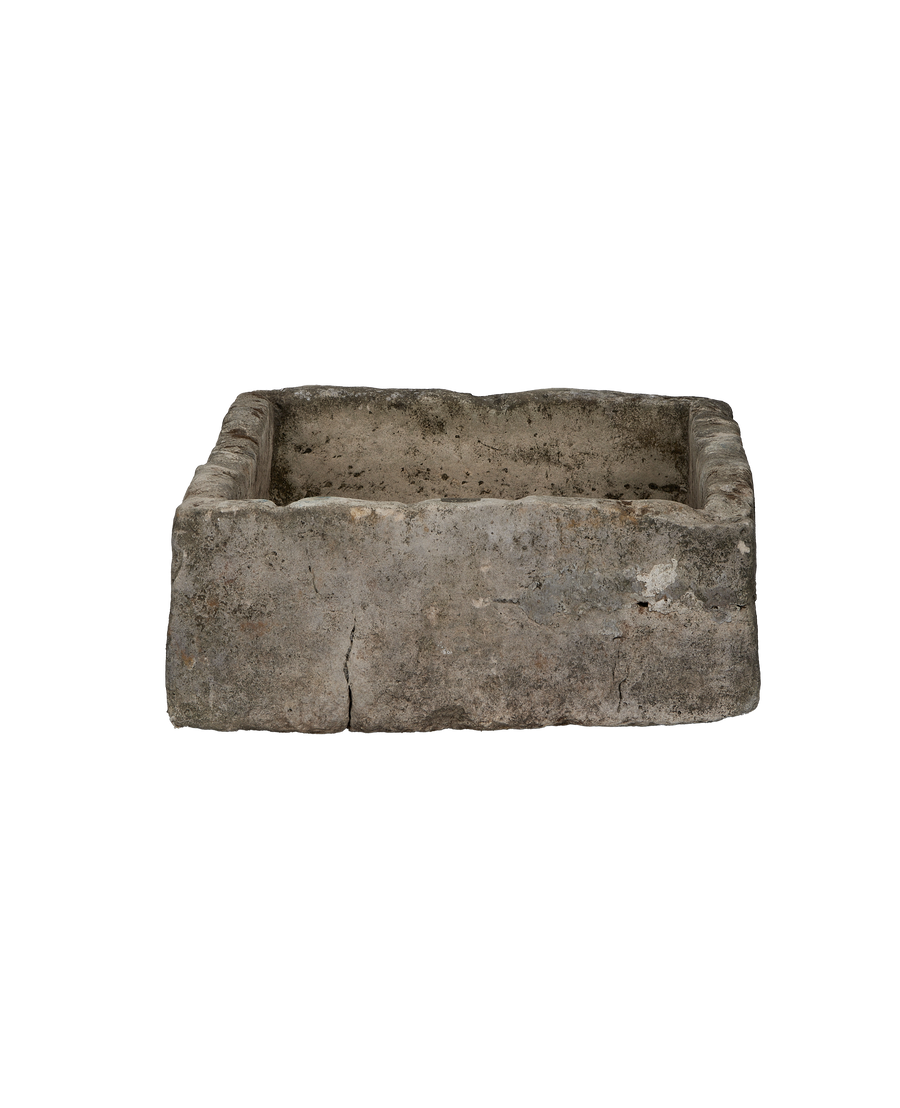 Vintage rectangular limestone trough, front view, showing weathered gray-brown patina and minor crack.