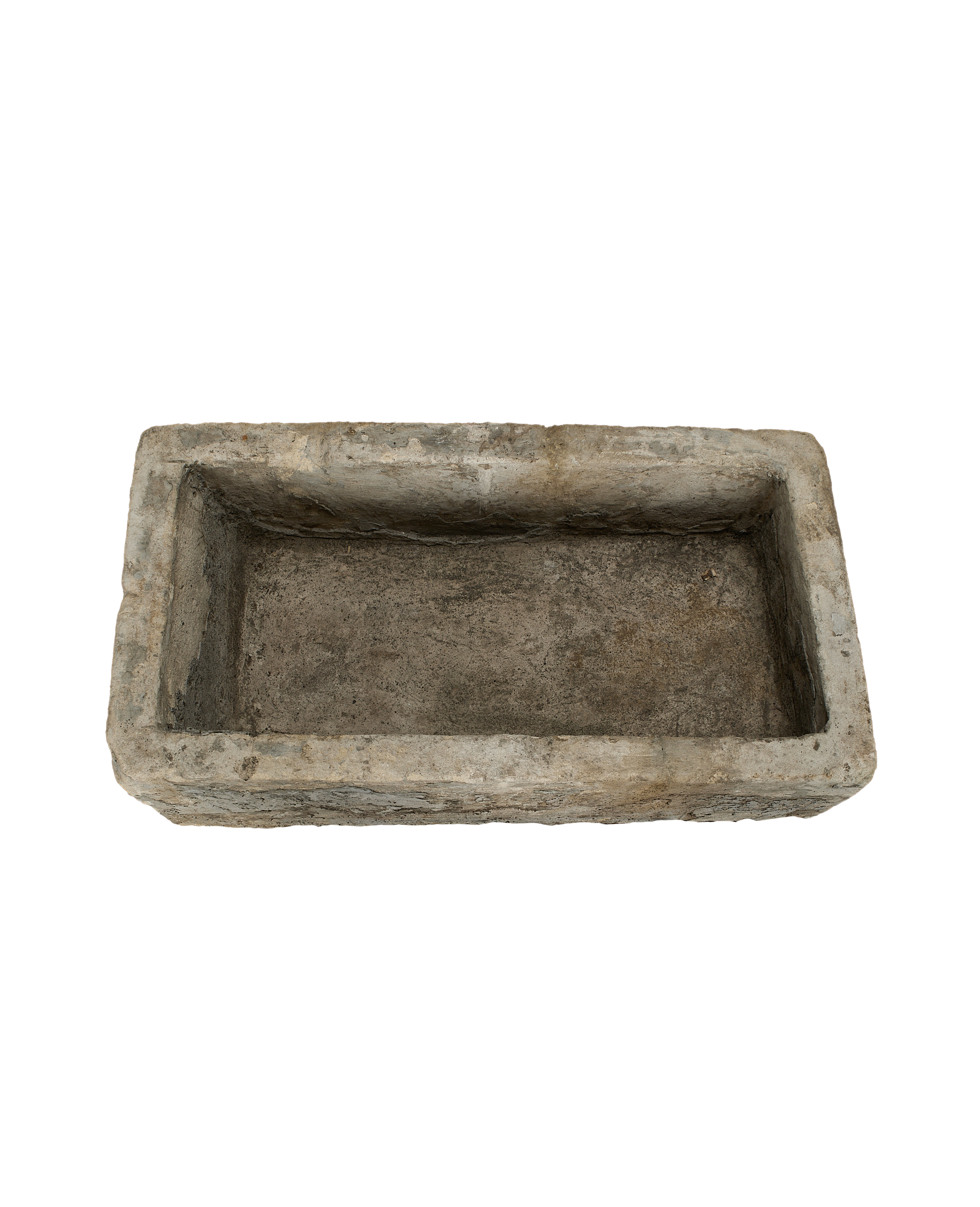 Top-down view of a vintage rectangular limestone trough with rough, aged texture.