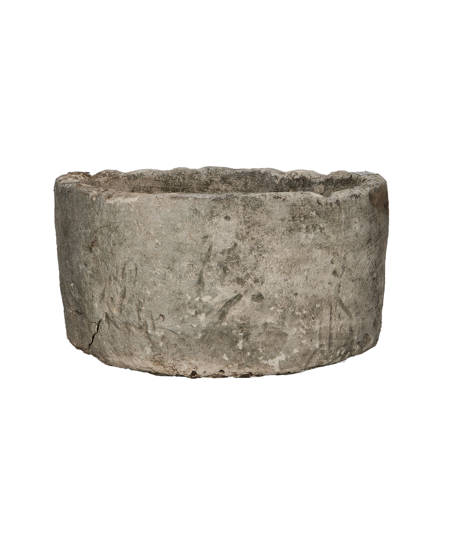 Vintage Indonesian limestone trough, showing rough textured exterior and small bottom crack.