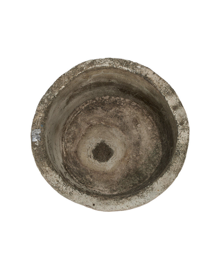 Vintage round Indonesian limestone trough, top-down view showing interior weathering and central drain hole.
