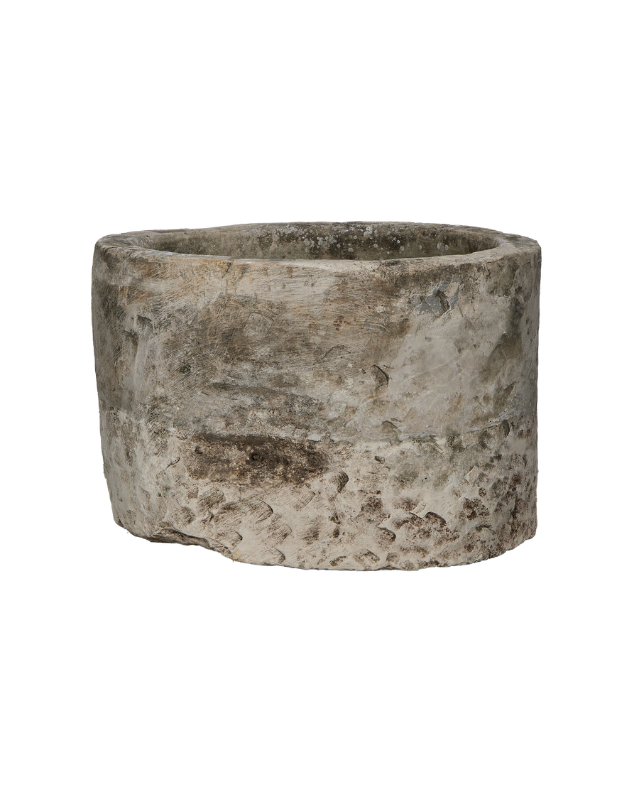 Vintage round Indonesian limestone trough, showing distressed texture and aged patina on the exterior.