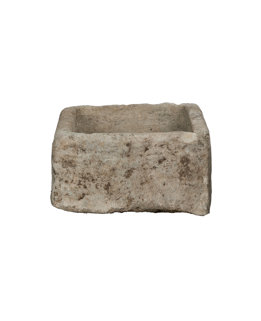 Vintage rectangular limestone trough, showing the rough, weathered texture and earthy patina.