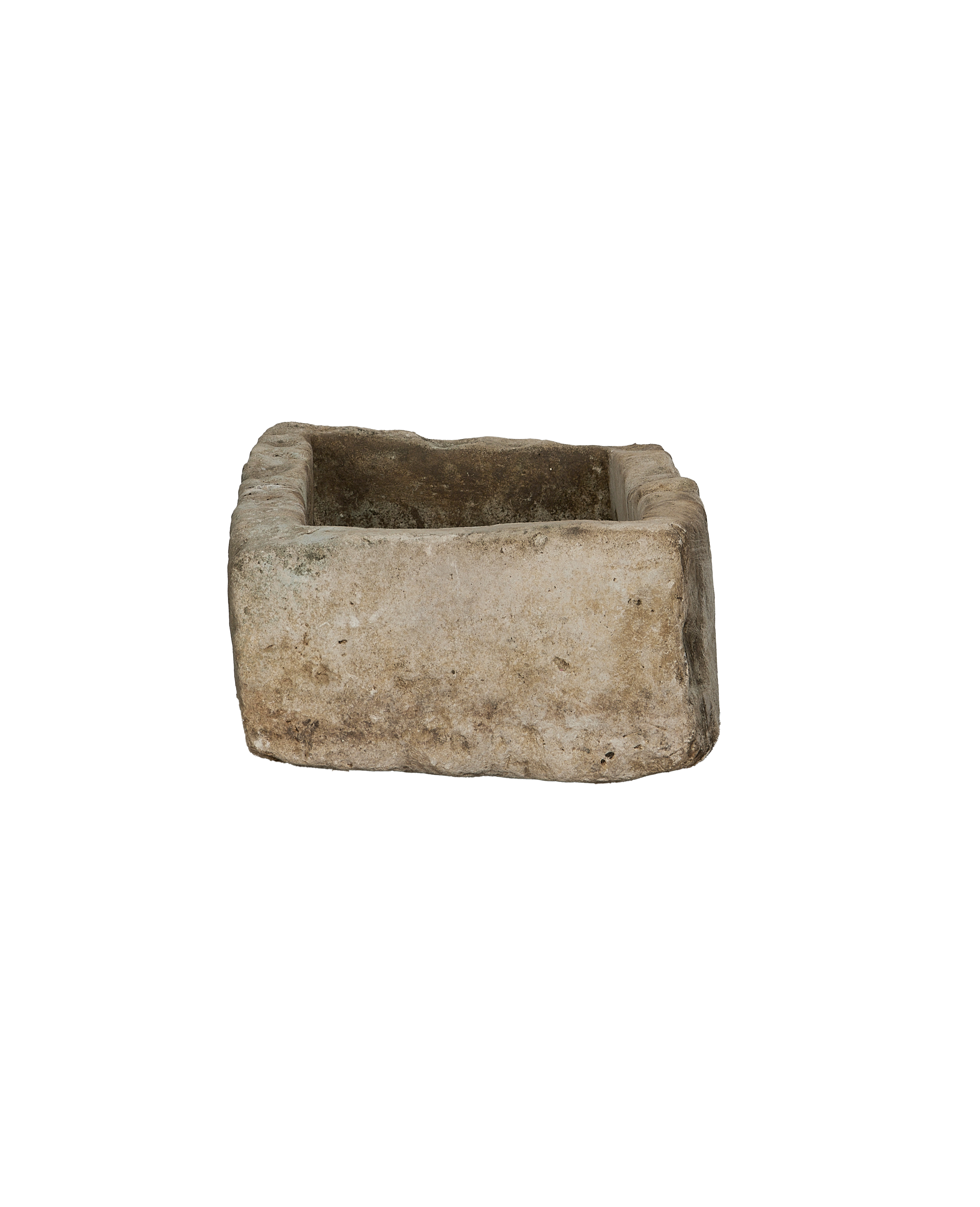 Vintage Indonesian limestone trough viewed from inside, showing rough textured interior and weathered edges.