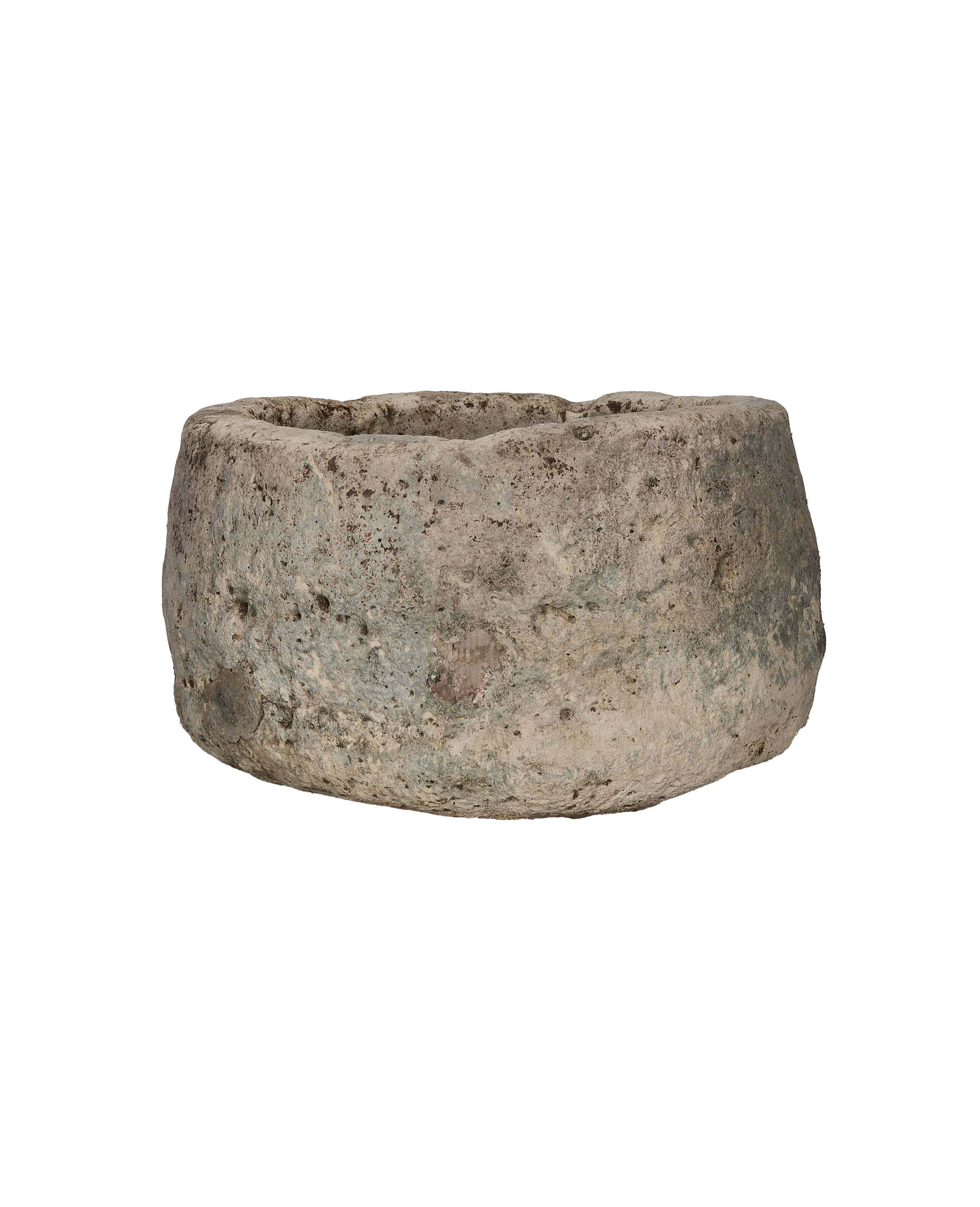 Vintage round Indonesian limestone trough, detailed side view showing rustic texture and weathered surface.