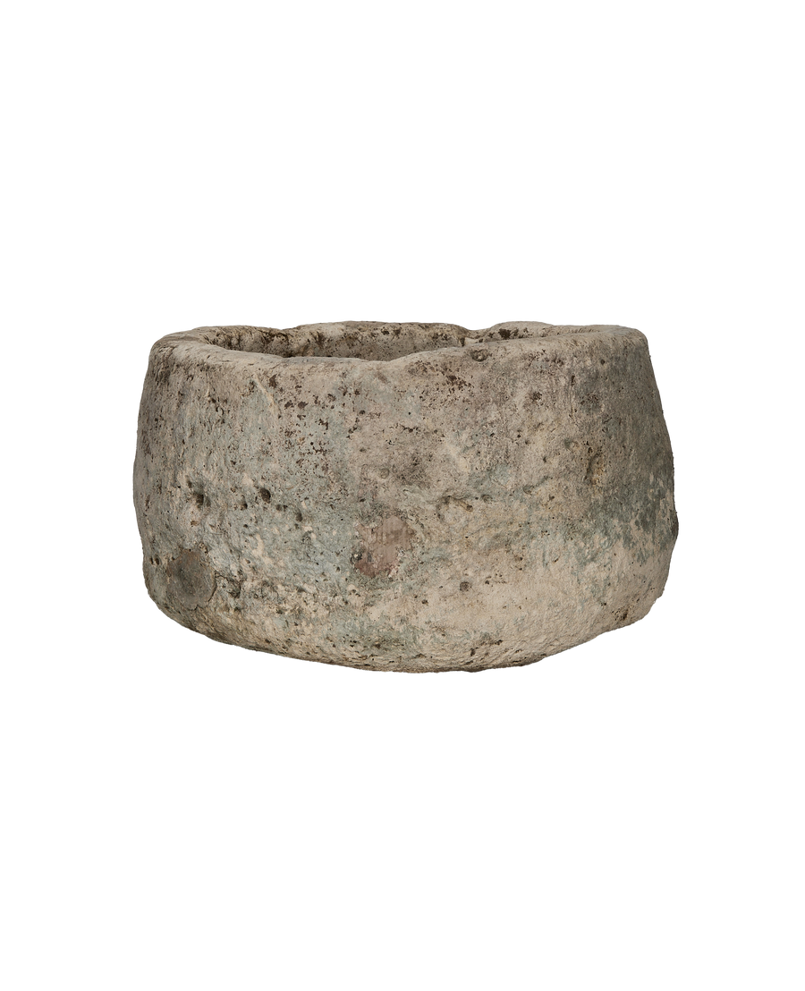 Vintage round Indonesian limestone trough, detailed side view showing rustic texture and weathered surface.