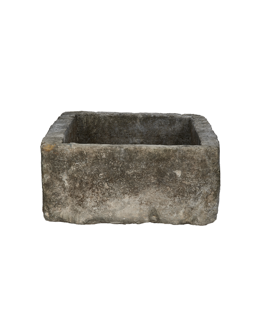 Vintage Indonesian limestone trough viewed from above, highlighting rustic gray texture and rectangular shape.