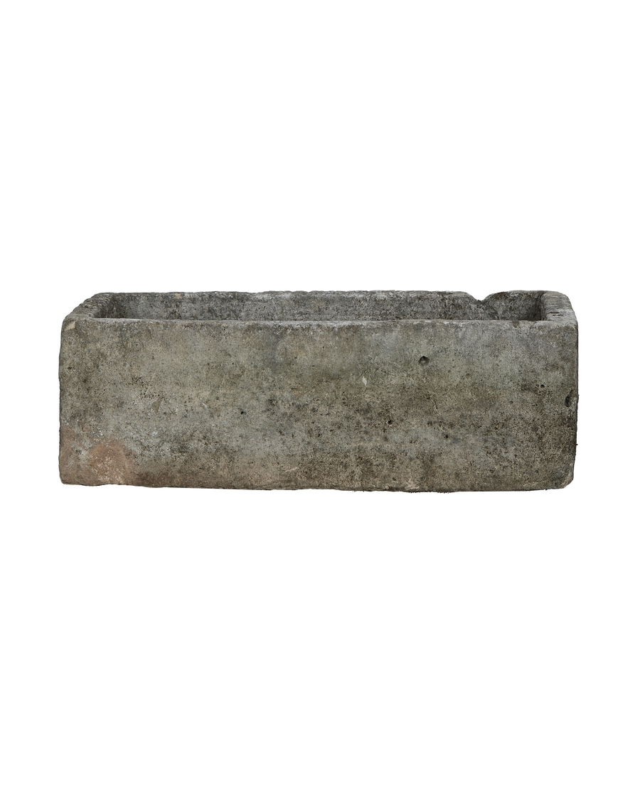 Vintage Indonesian rectangular limestone trough, detailed texture of the weathered gray, rough surface.