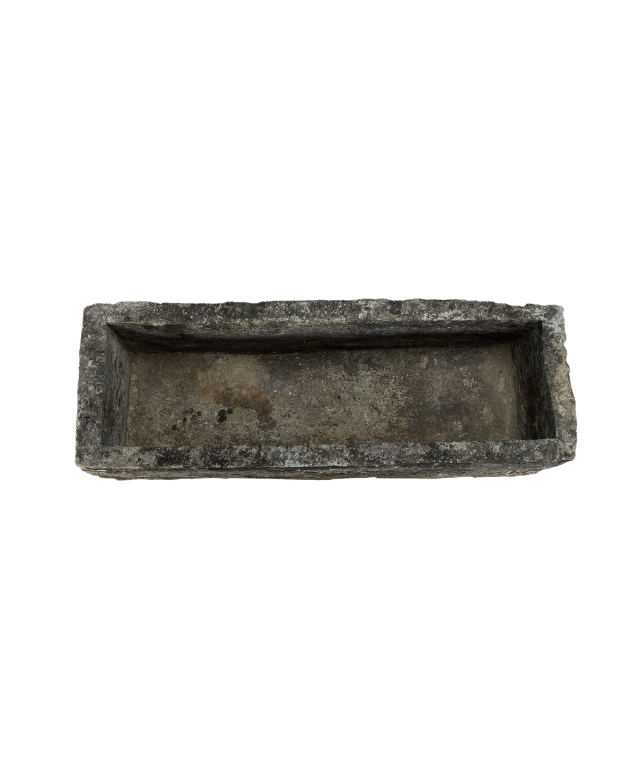 Vintage rectangular Indonesian limestone trough with rough-hewn texture, dark aged patina.