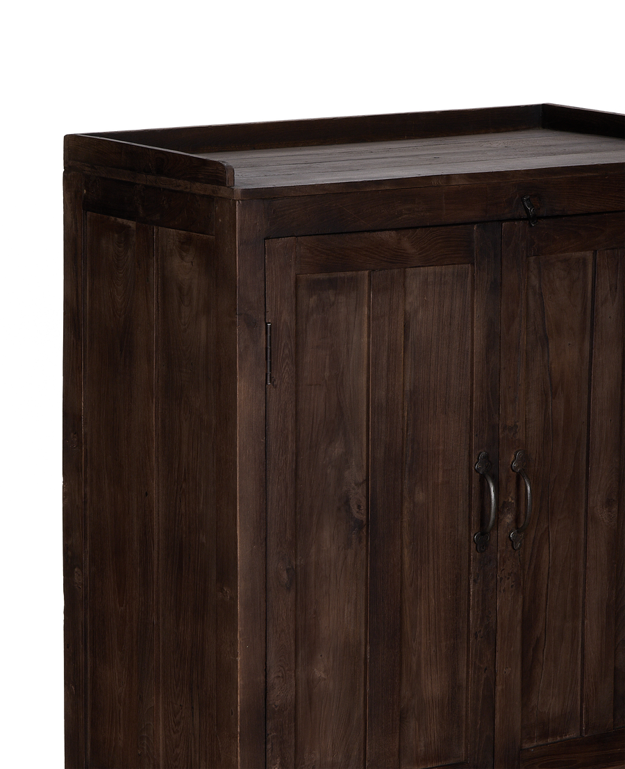 Vintage dark oak cabinet from India, showing rustic detailed top and cabinet doors.