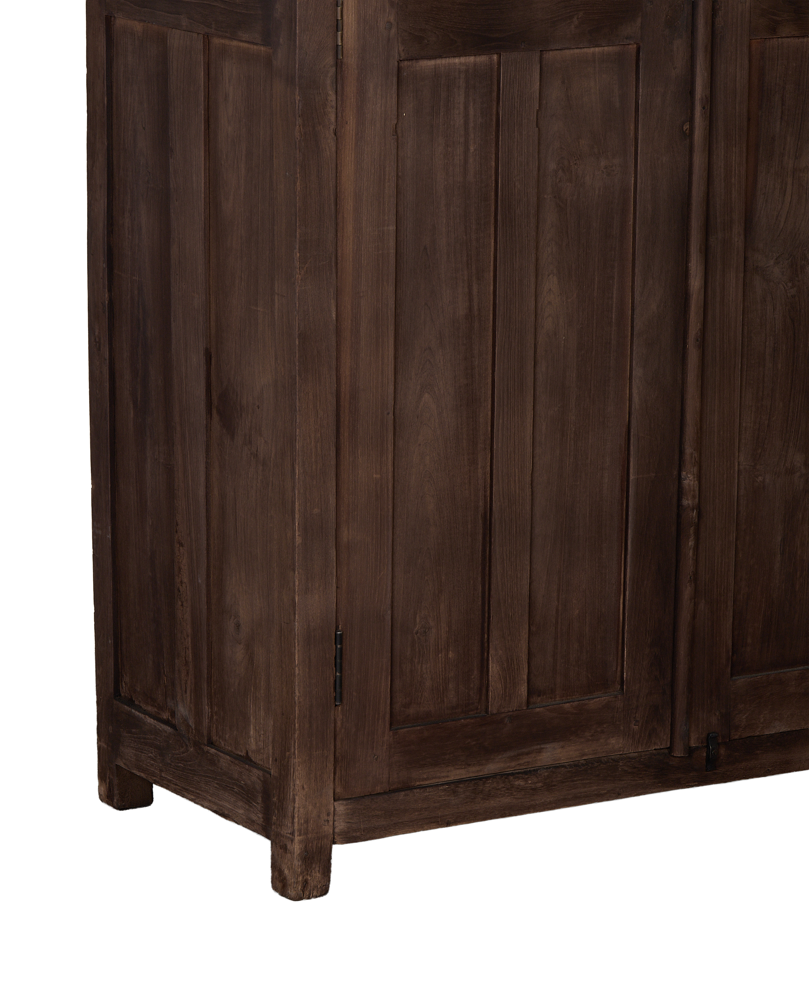 Vintage oak cabinet's bottom corner, showcasing natural wood grain and simple leg detail.