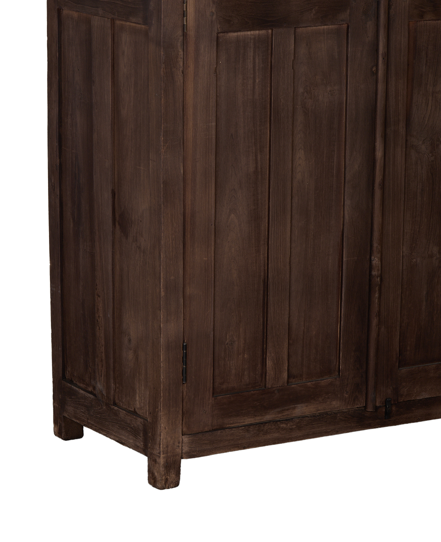 Vintage oak cabinet's bottom corner, showcasing natural wood grain and simple leg detail.