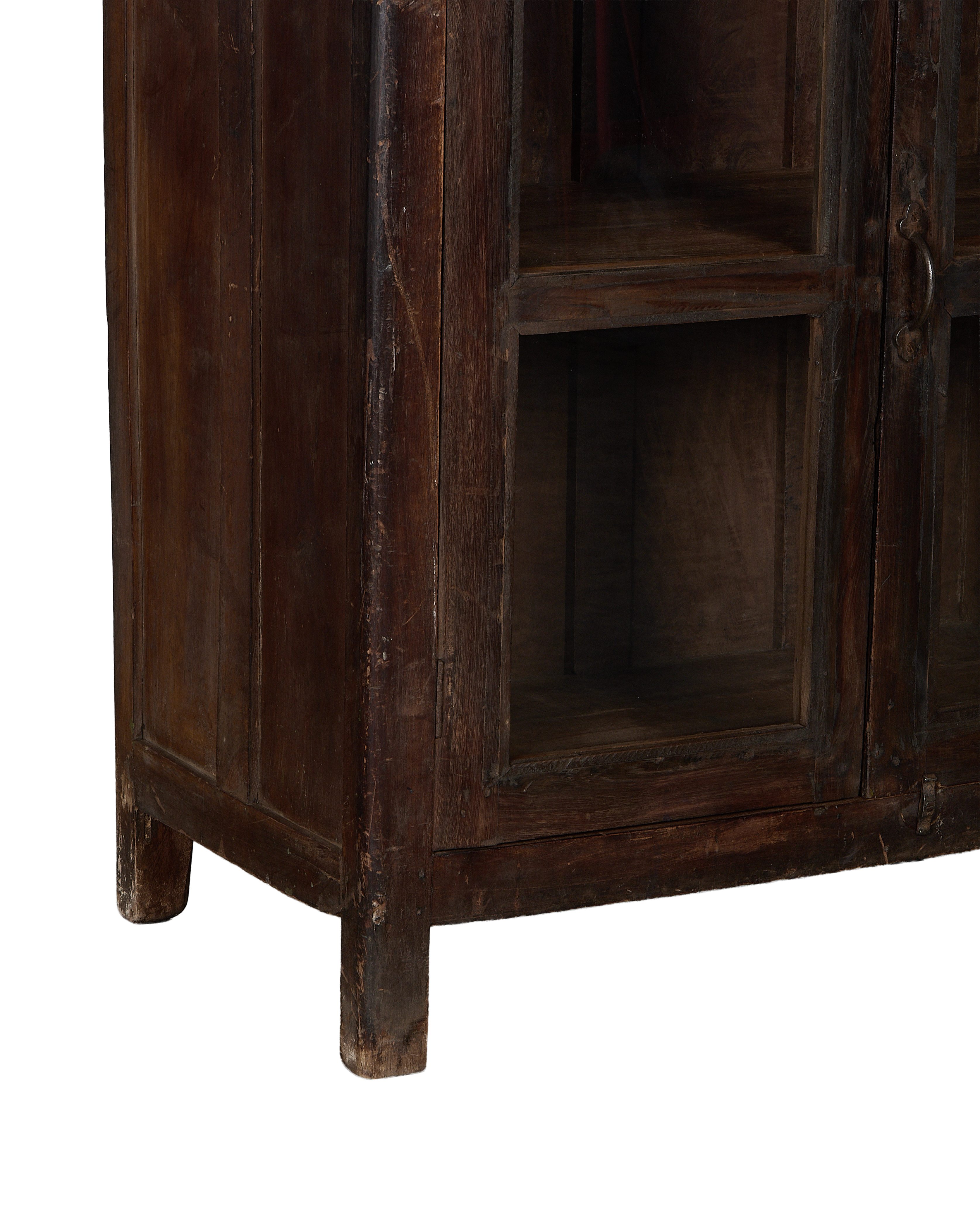 Vintage Indian oak cabinet bottom showing sturdy feet and distressed dark wood finish.