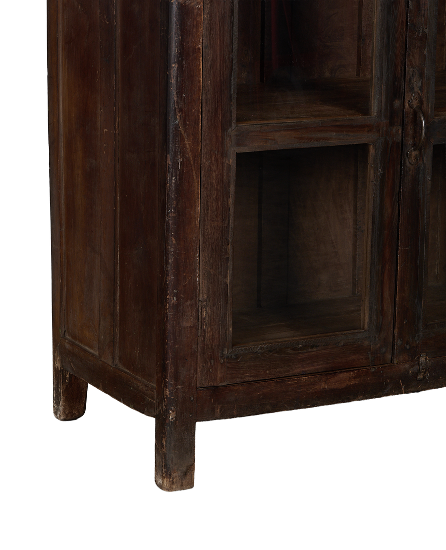 Vintage Indian oak cabinet bottom showing sturdy feet and distressed dark wood finish.