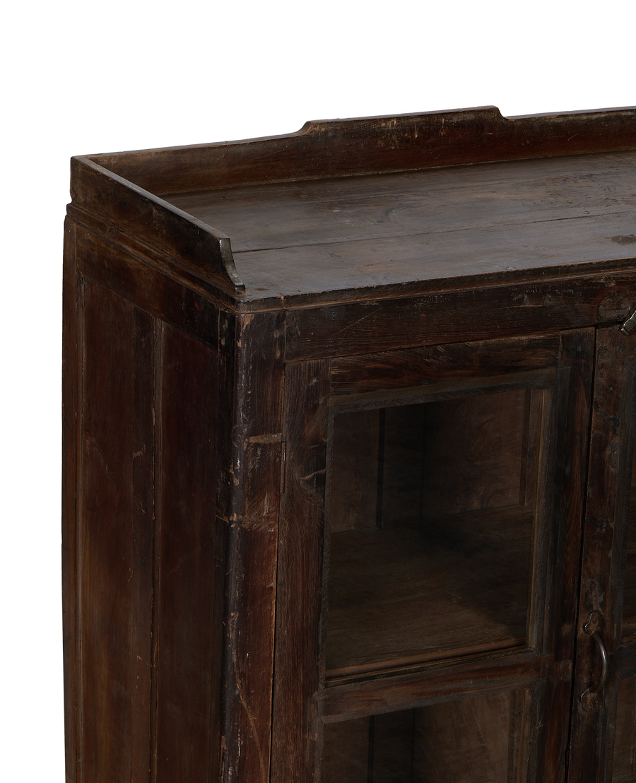 Vintage Indian oak cabinet: detailed close-up of aged wood grain and glass panels.