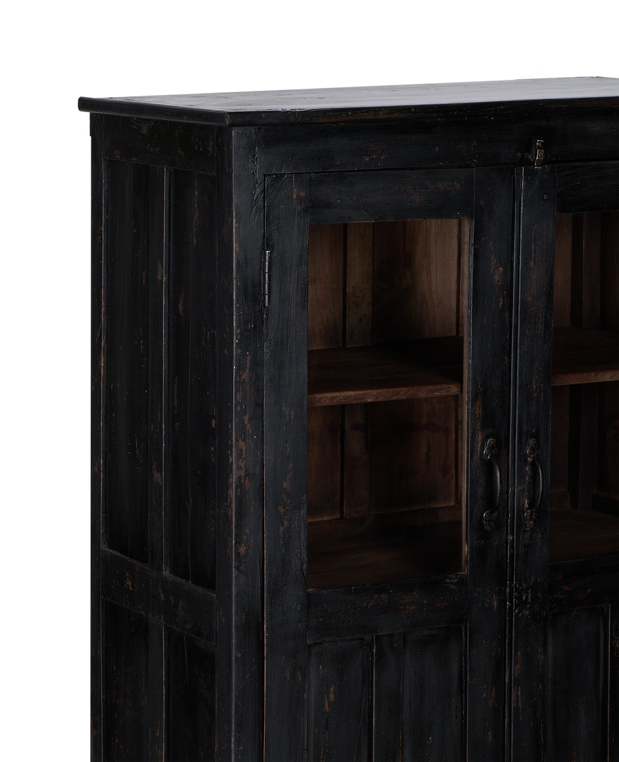 Close-up left side of vintage black stained oak cabinet showcasing glass doors and handles.