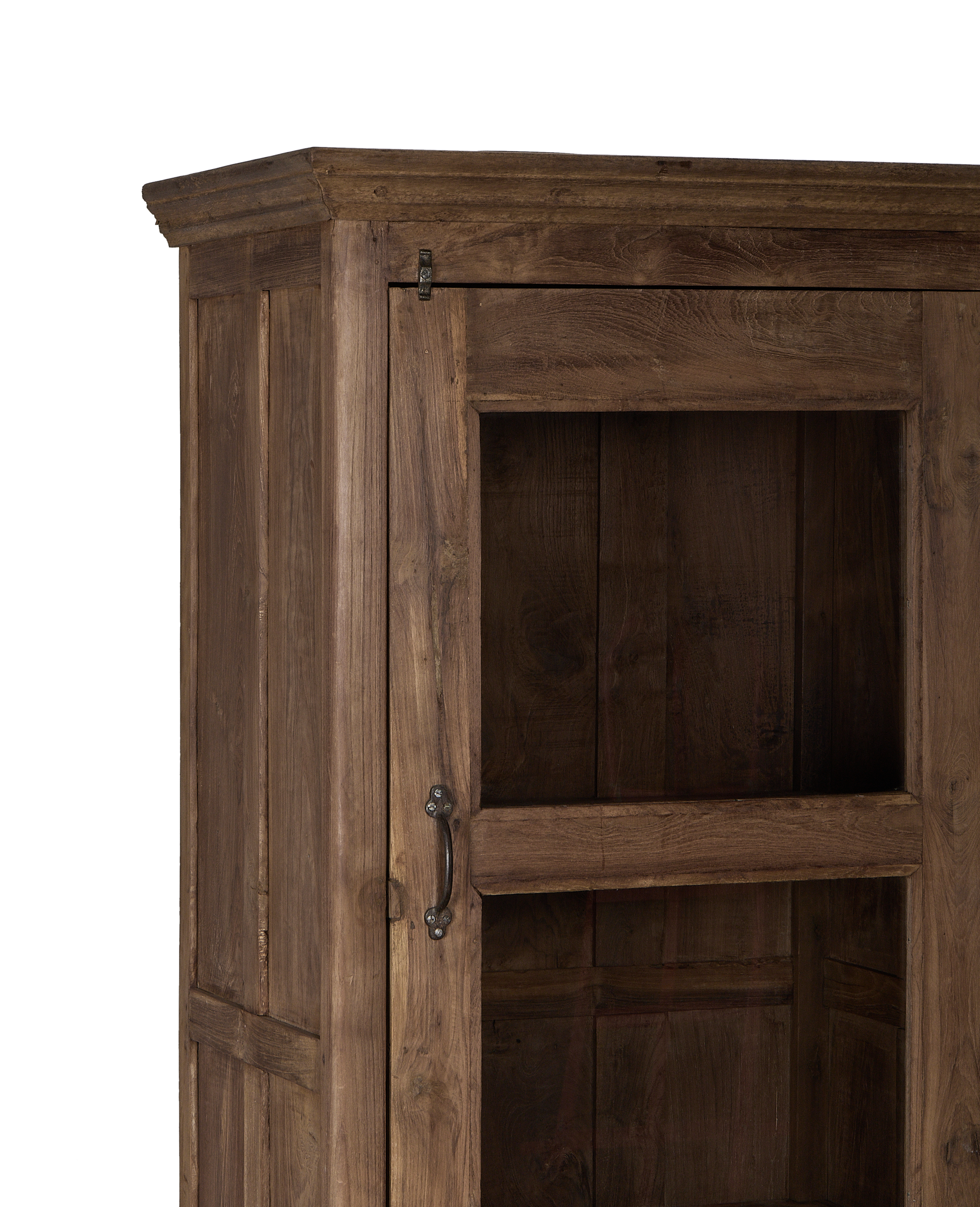 Close-up of vintage Indian oak cabinet door with distressed wood grain, glass, and antique metal handle.