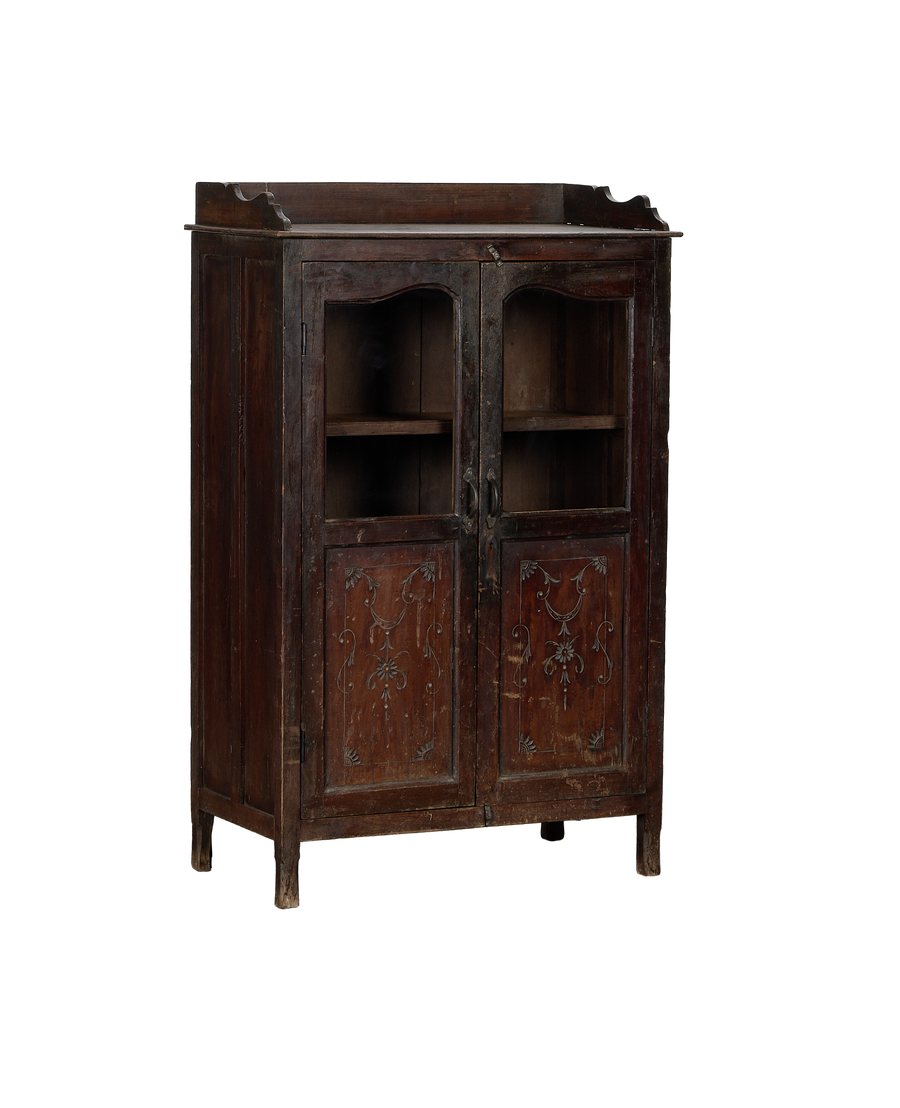 Vintage Indian oak cabinet, full frontal view, showing glass doors, brass hardware, and detailed lower carvings.