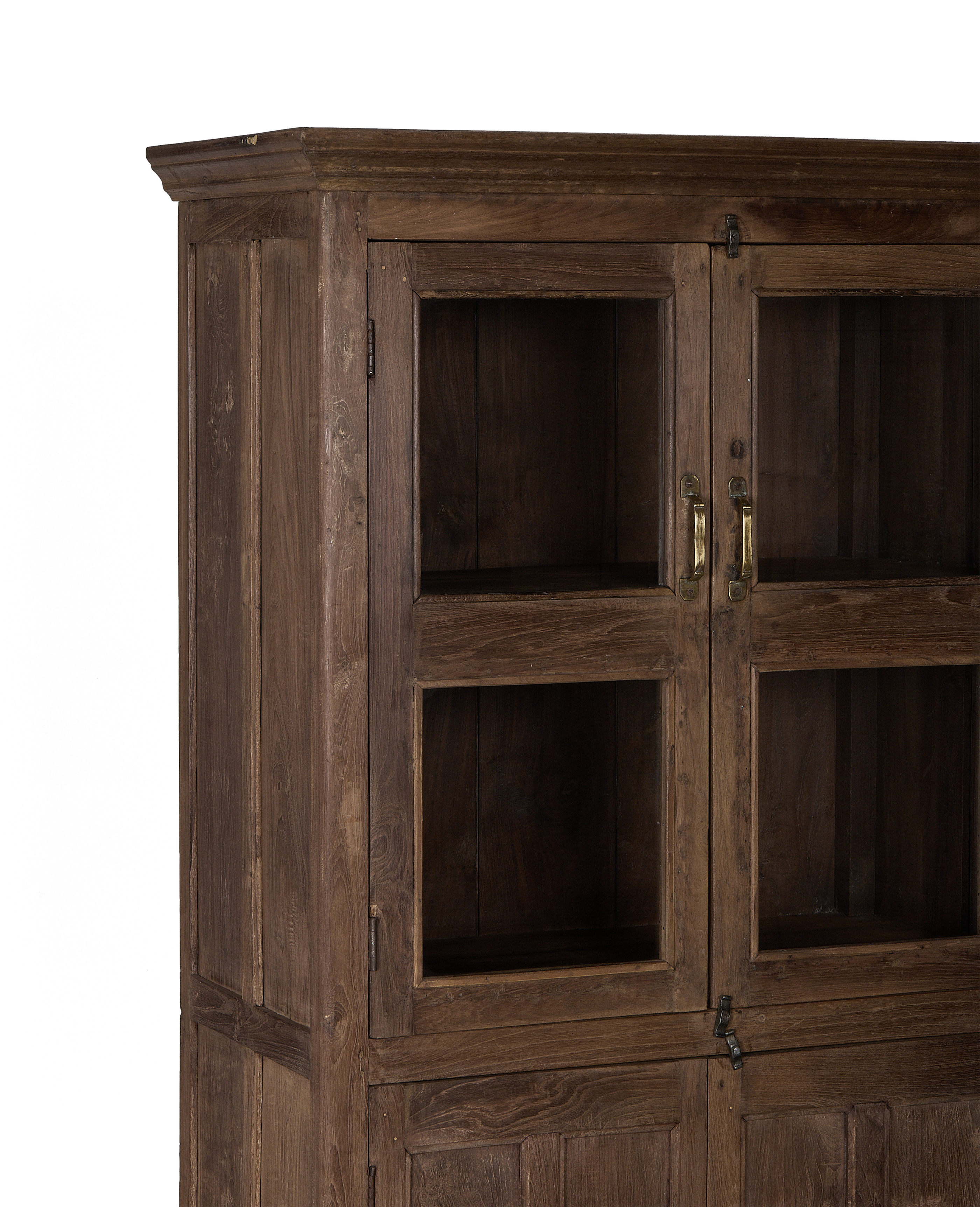 Vintage Indian oak cabinet, glazed doors, natural wood grain, brass pulls, dark background.