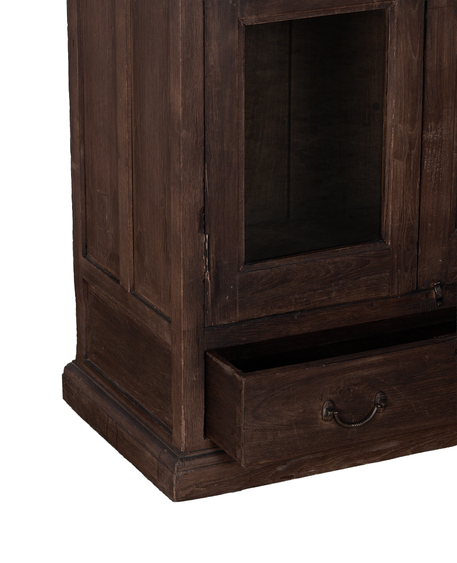 Vintage Indian oak cabinet bottom showing open drawer with antique brass pull.