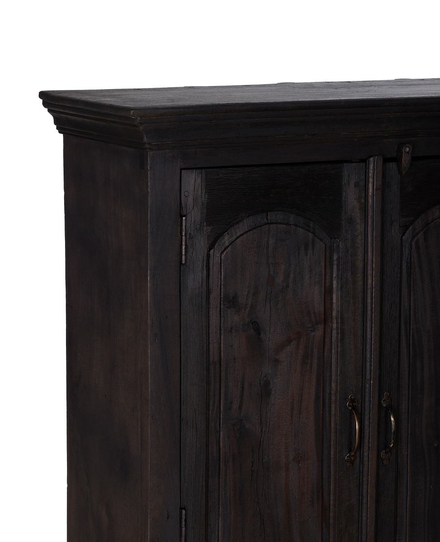 Detailed top right corner of vintage stained oak cabinet from India.