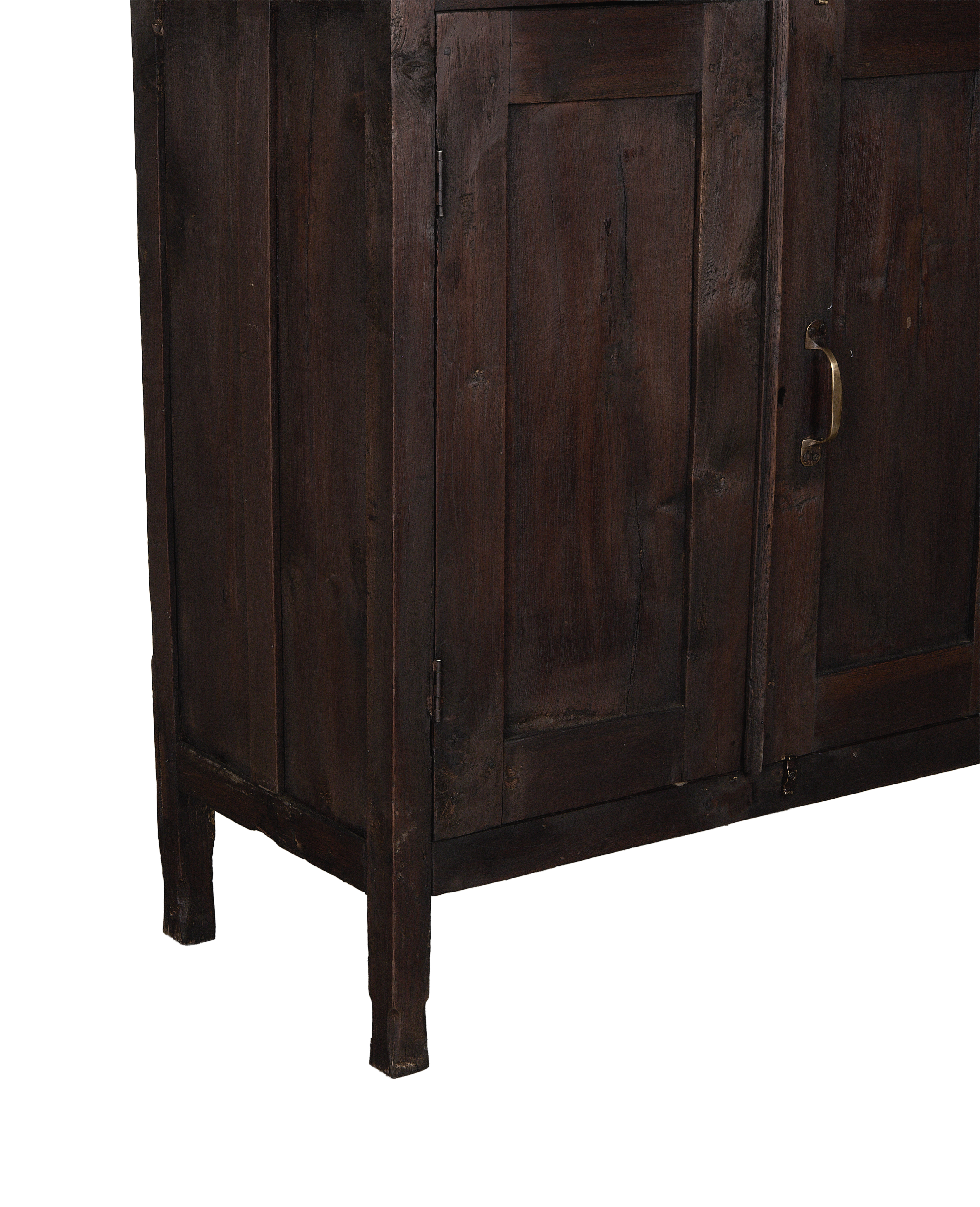 Close-up of vintage Indian oak wood cabinet's stained dark finish and brass handle.