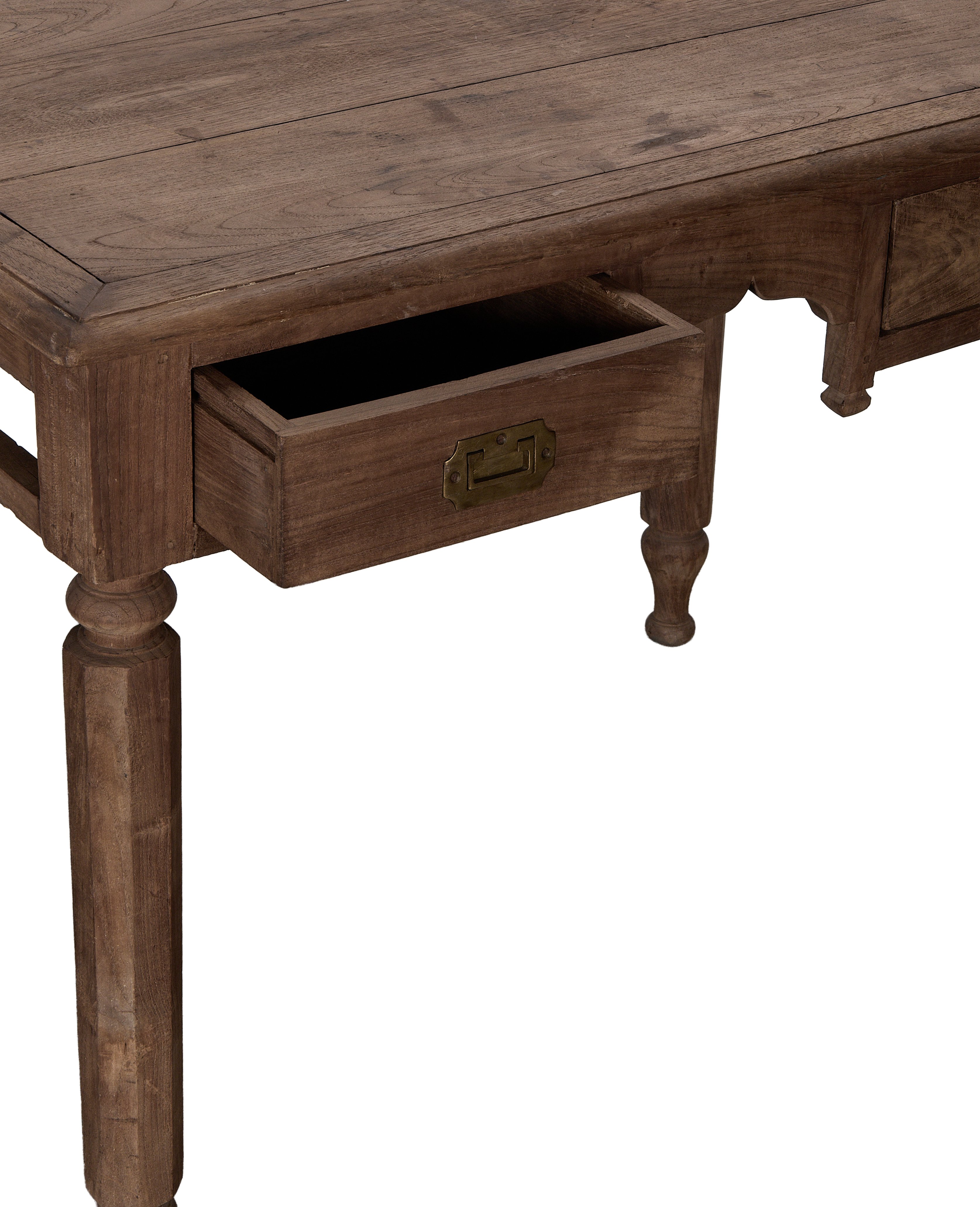 Vintage oak wood desk with pulled-out drawer showing brass pull, ornate legs.