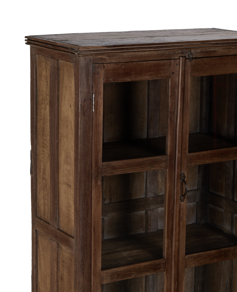 Vintage oak display cabinet from India, showing closed glass doors and interior shelves.