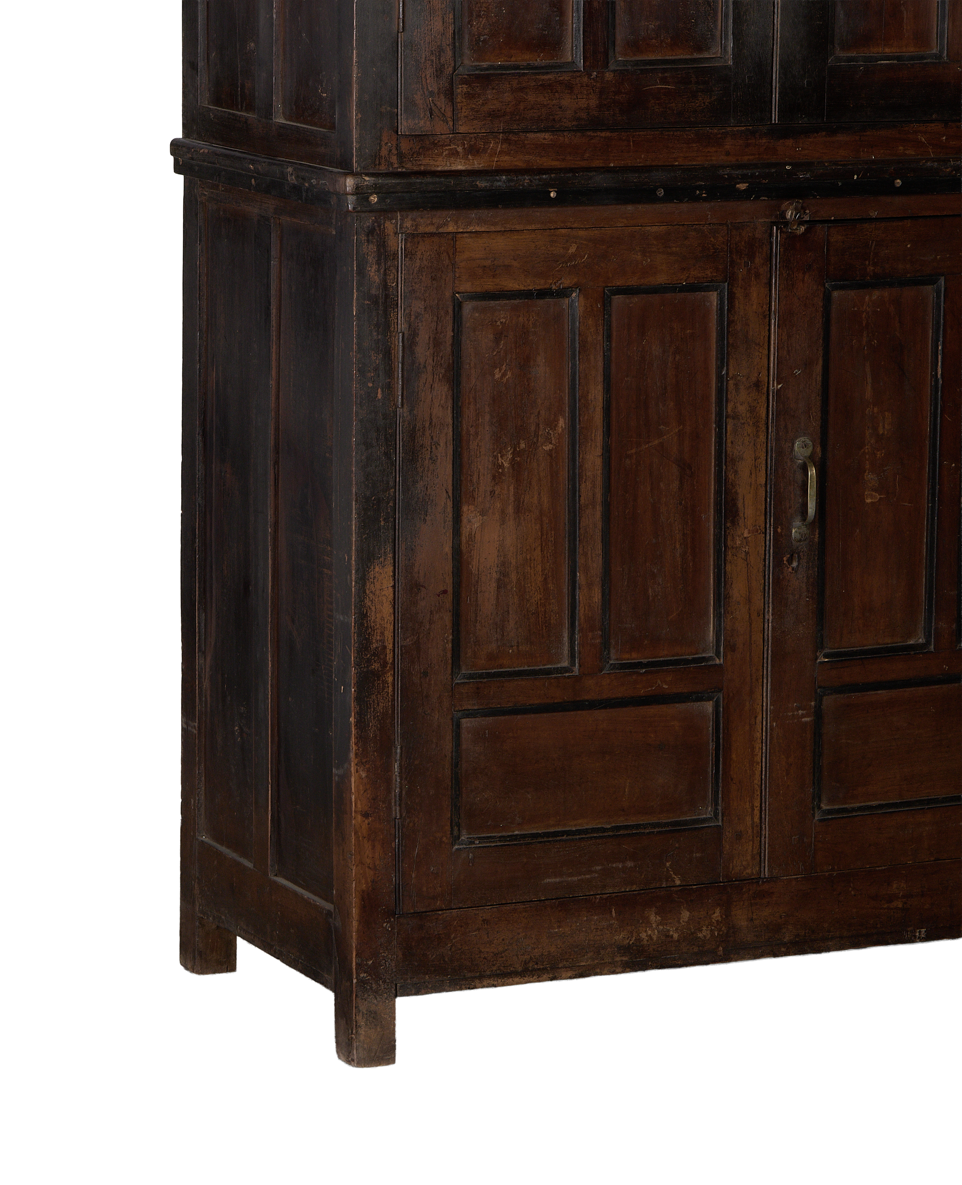 Lower section of vintage Indian oak wood cabinet, showing distressed stained finish and aged metal pull on double doors.