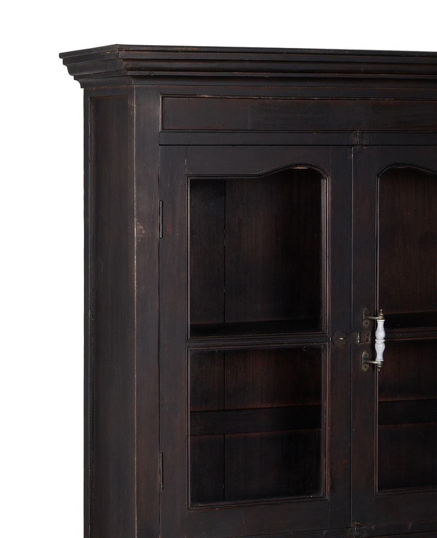 Vintage dark stained Indian oak cabinet, showing intricate molding and glass display shelves.