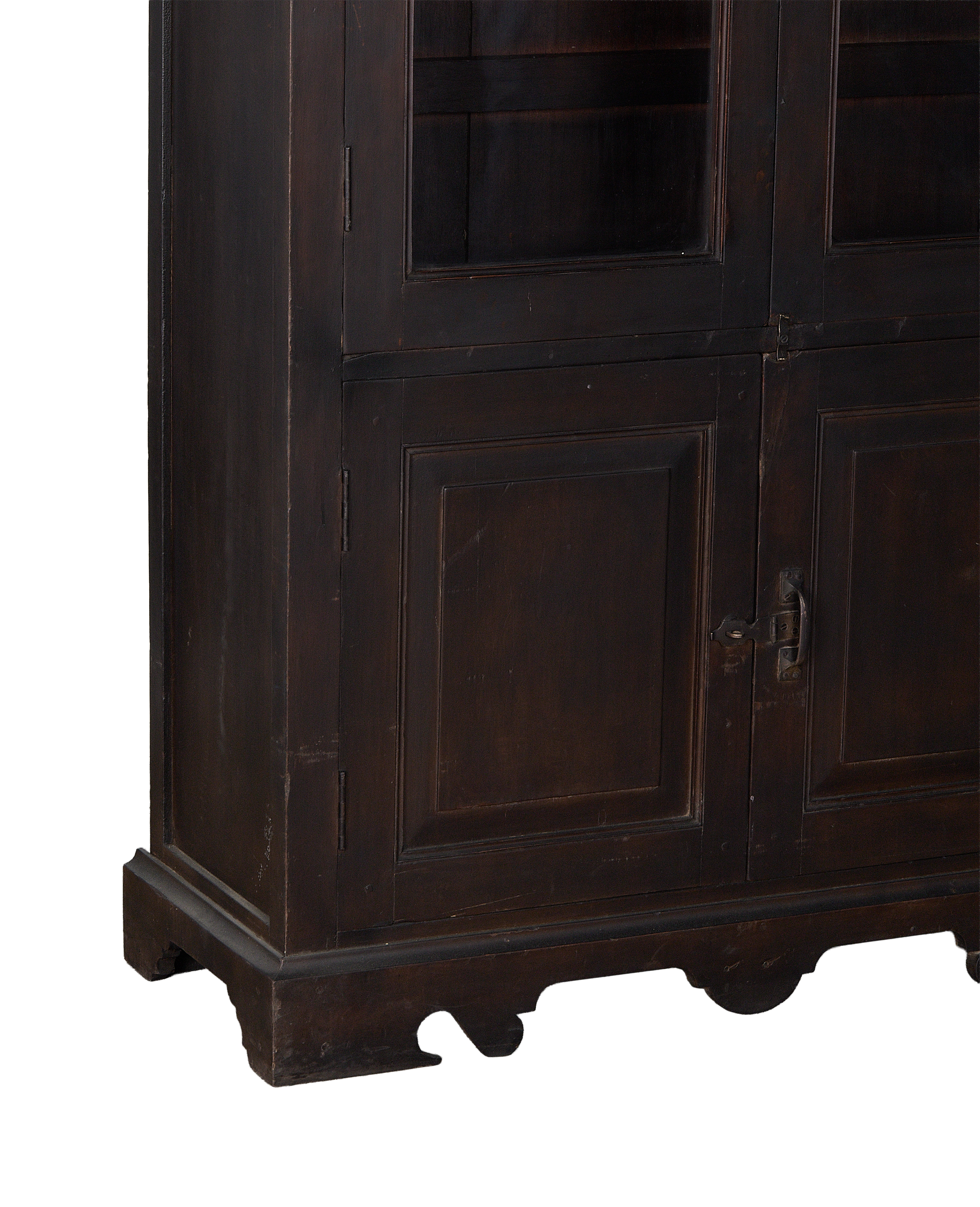 Vintage dark stained oak cabinet, visible lower doors and decorative carved base.