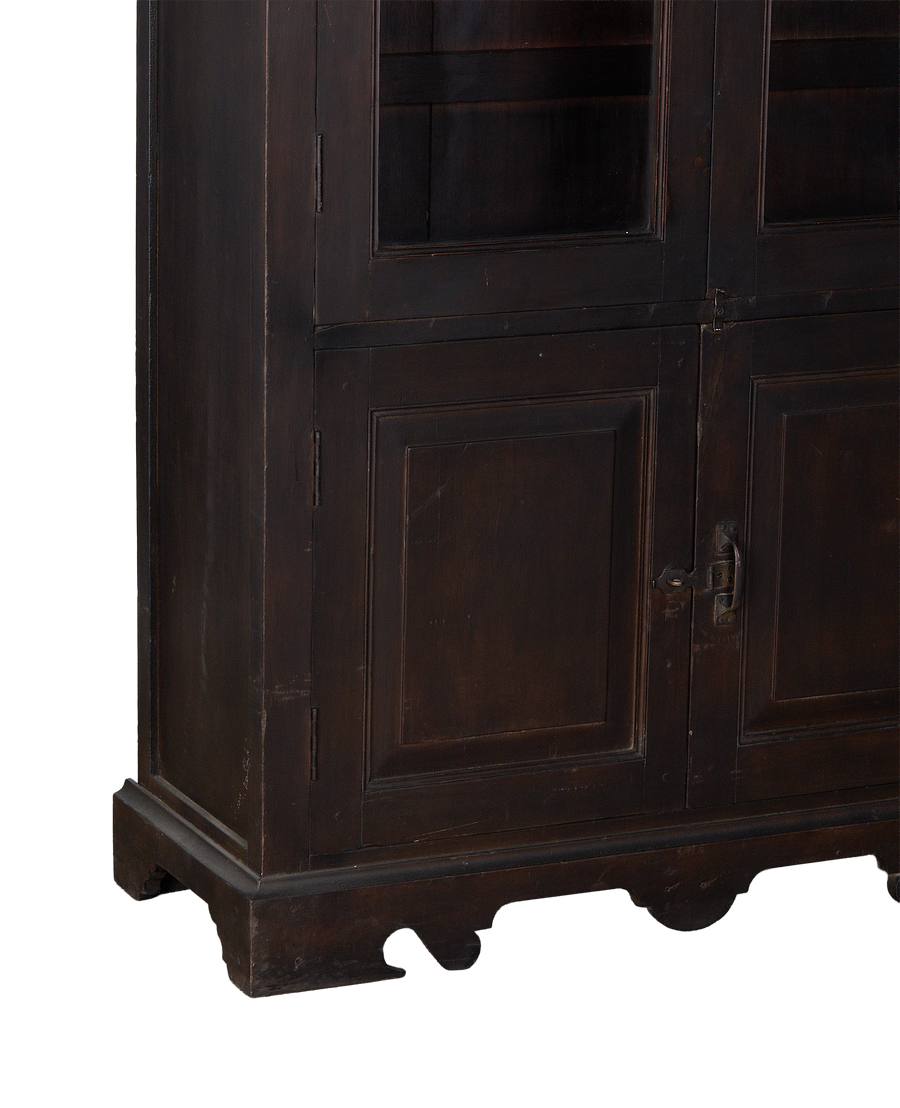 Vintage dark stained oak cabinet, visible lower doors and decorative carved base.