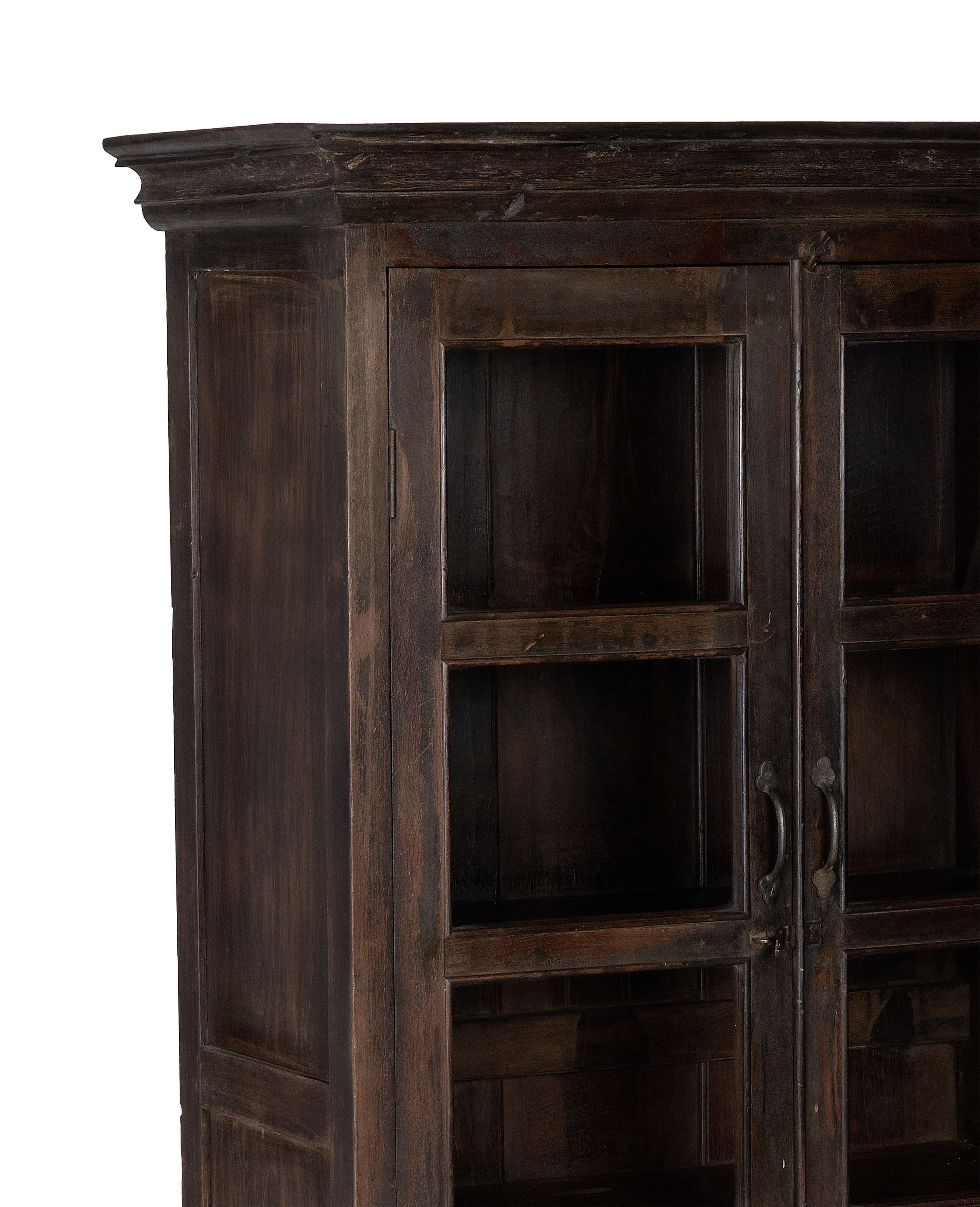 Close-up of vintage Indian oak wood cabinet's ornate crown molding and naturally distressed finish.