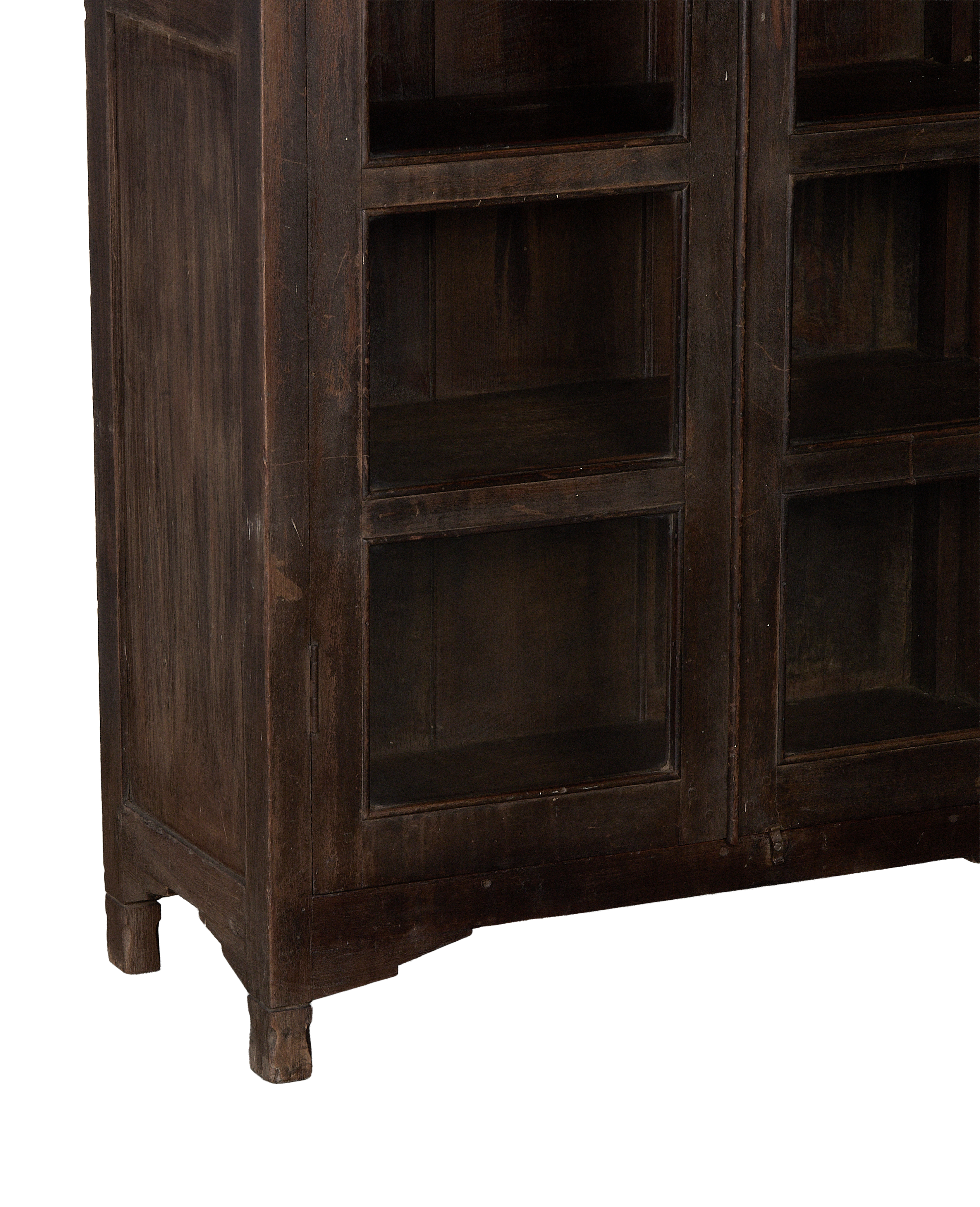 Vintage Indian oak cabinet: detailed close-up of dark wood finish, glass door panels and distressed feet.