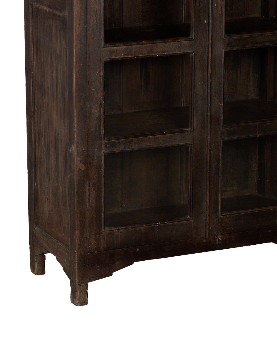 Vintage Indian oak cabinet: detailed close-up of dark wood finish, glass door panels and distressed feet.