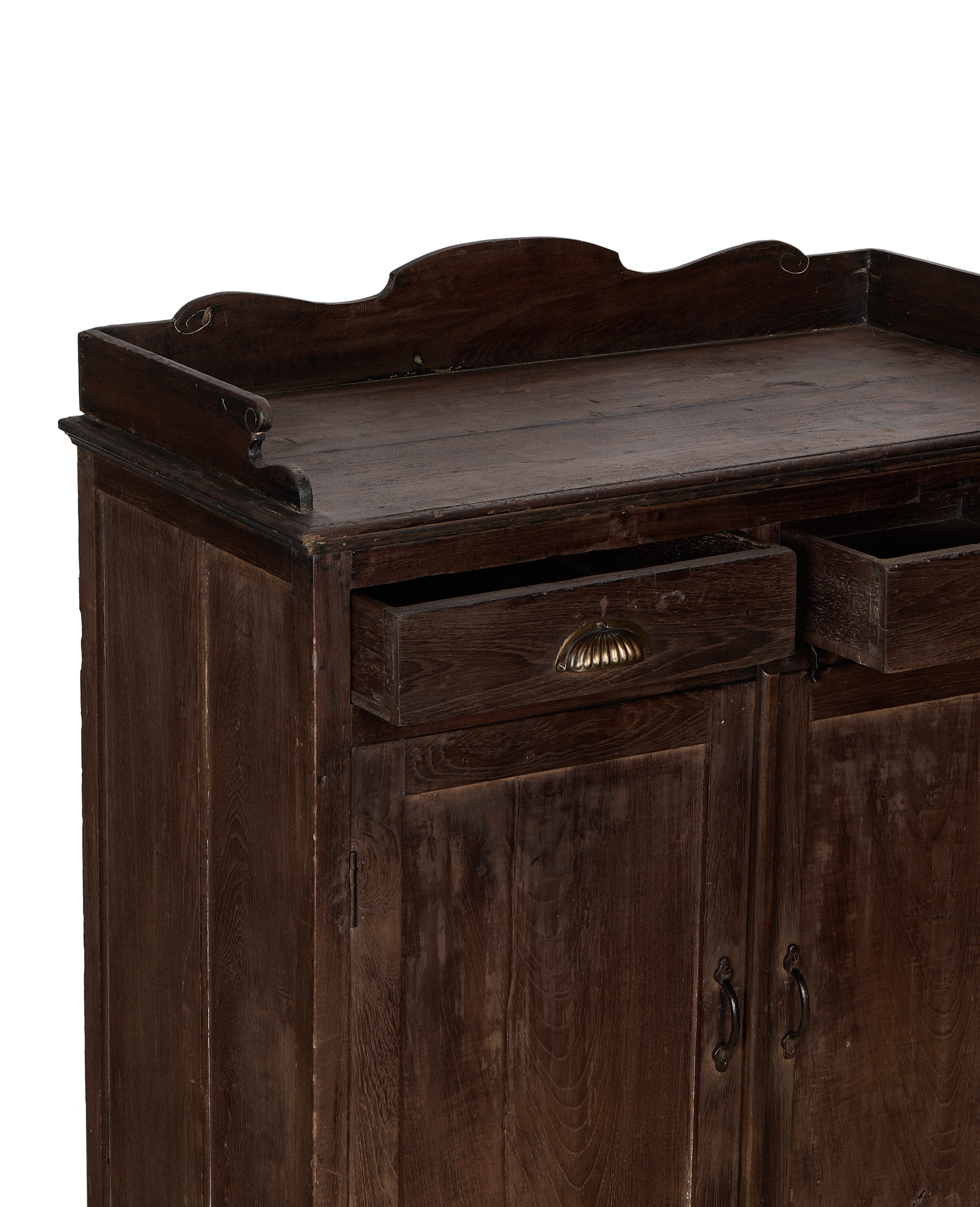 Vintage Indian oak cabinet showing partially open drawers with brass pulls, and doors below.