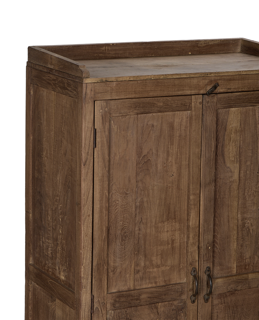 Close-up of vintage Indian oak wood cabinet with natural grain and rustic metal latch.