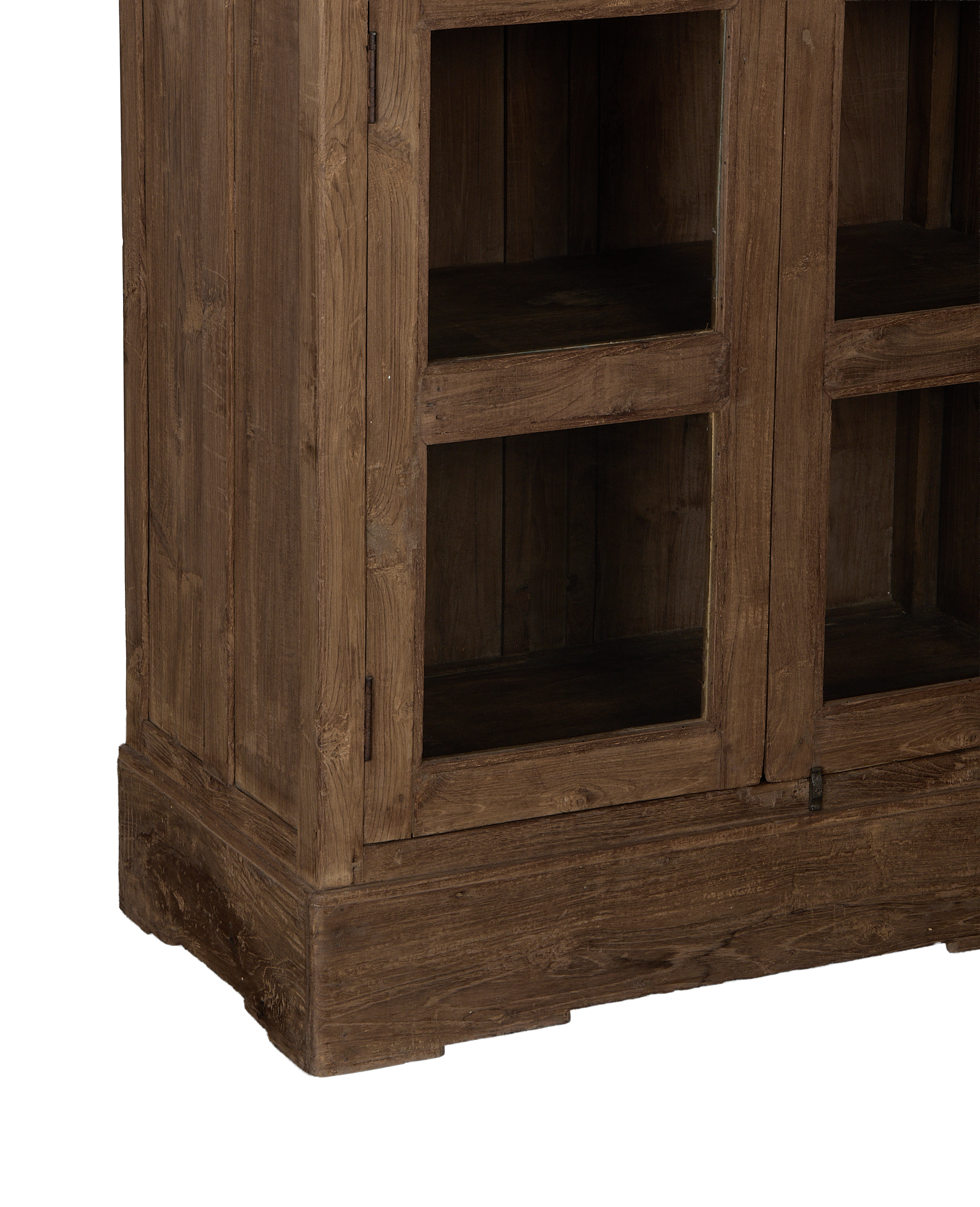 Vintage Indian oak cabinet closeup, revealing natural wood grain, textured base, and detailed glass door frame.
