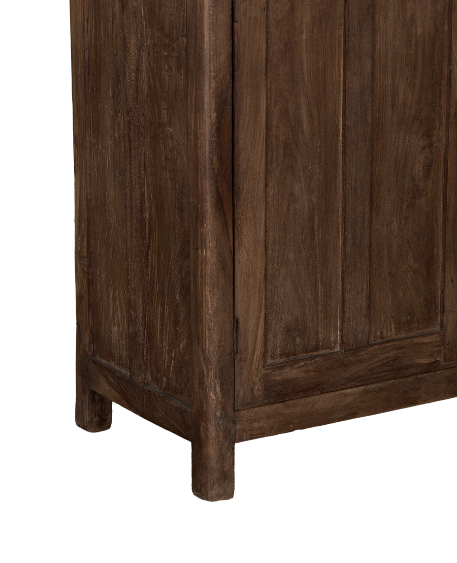 Vintage Indian oak cabinet bottom corner, showing natural wood texture and sturdy design.