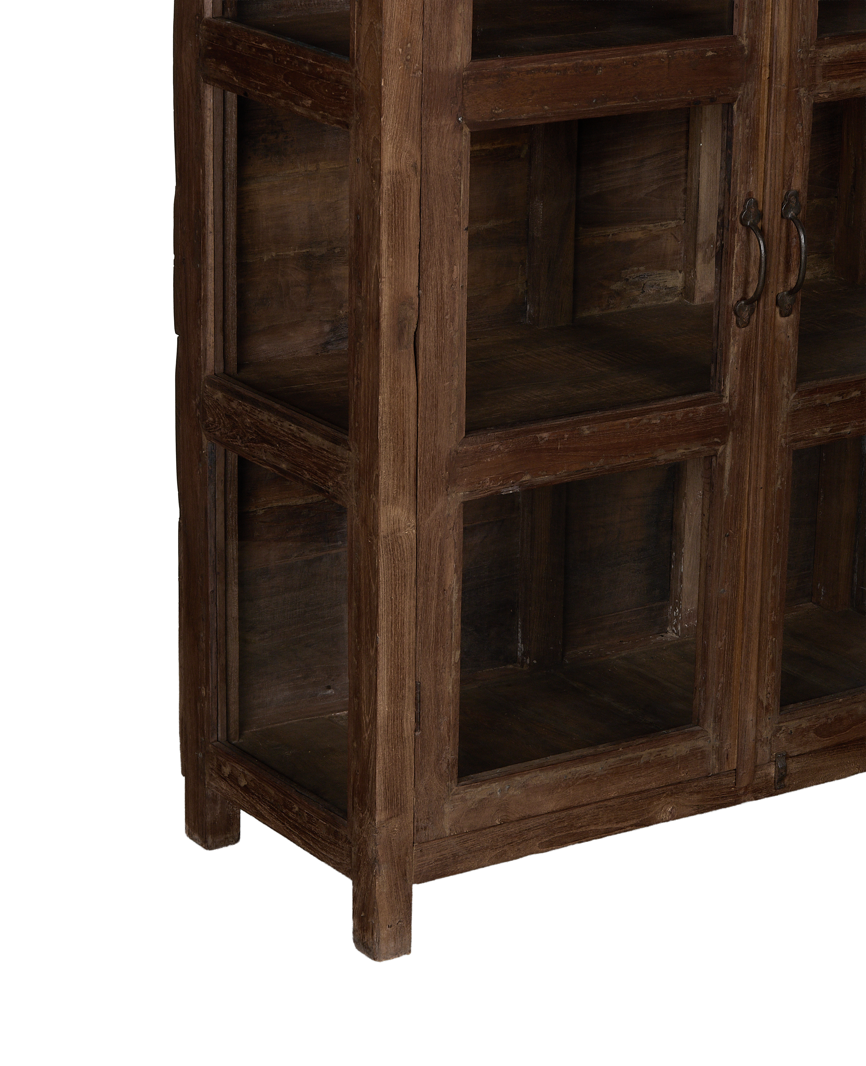 Side view of vintage Indian oak wood curio cabinet, showing doors and rustic handles.