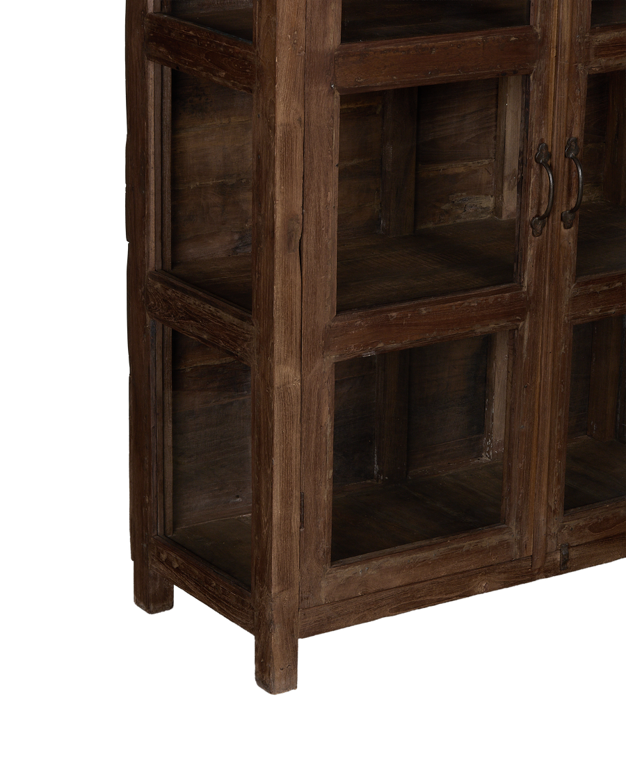 Side view of vintage Indian oak wood curio cabinet, showing doors and rustic handles.
