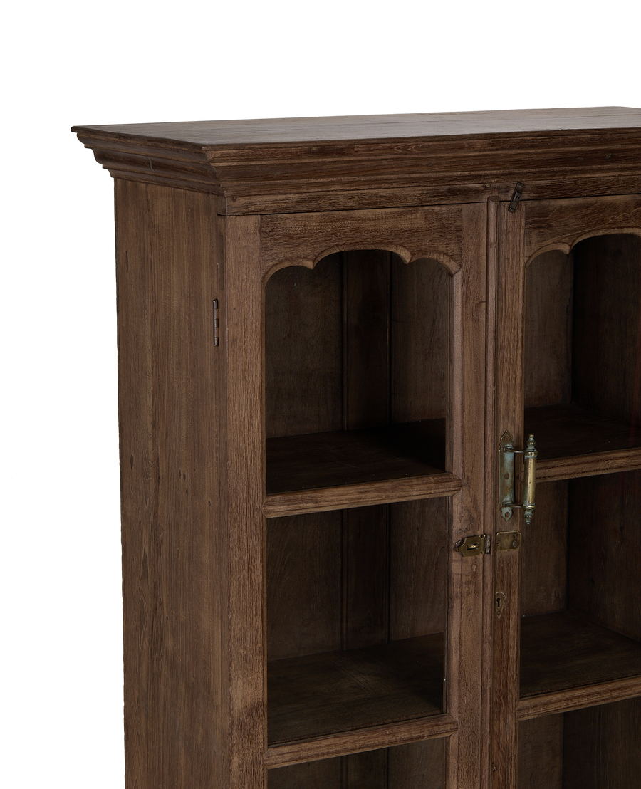 Vintage Indian oak cabinet: detailed close-up of decorative arched shelves and ornate latch.