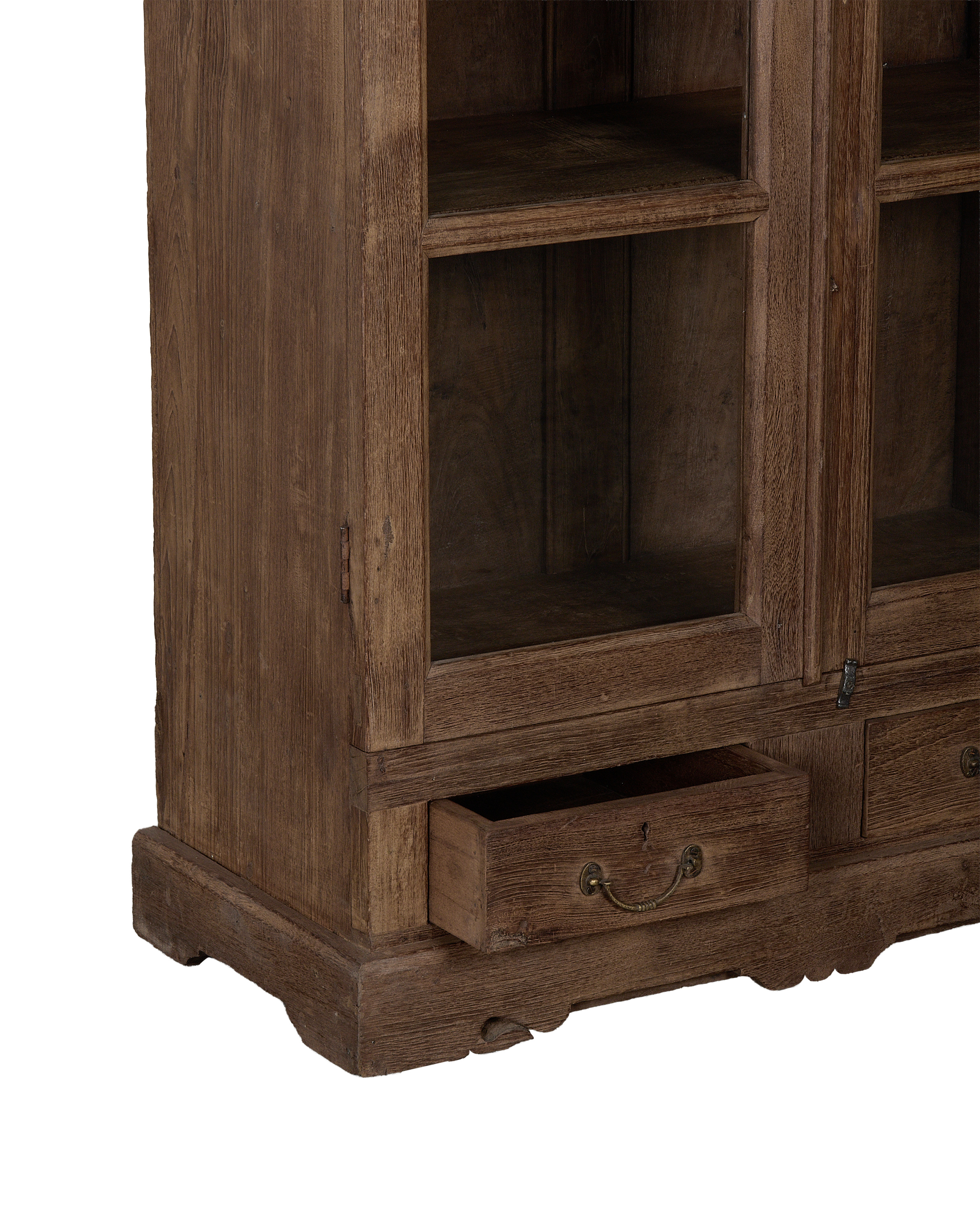 Vintage Indian oak cabinet featuring an open bottom drawer with ornate brass pull.