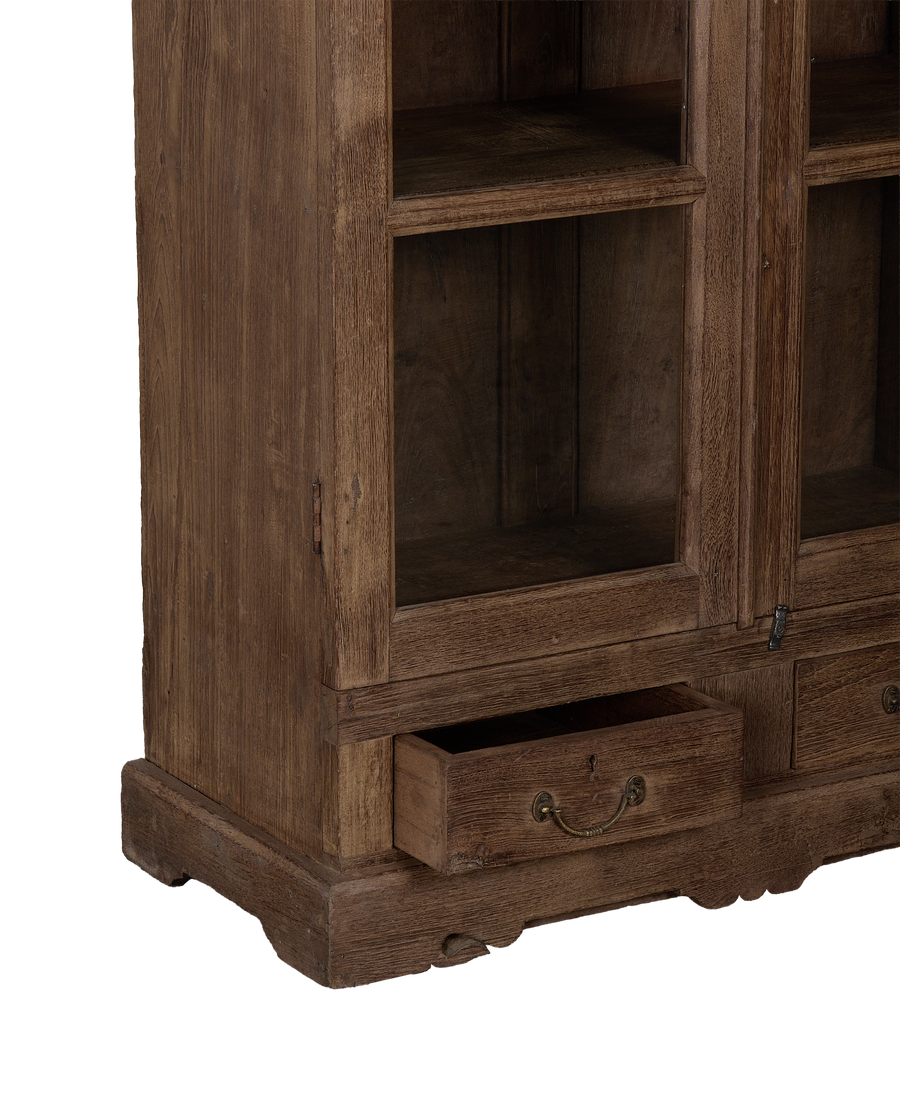 Vintage Indian oak cabinet featuring an open bottom drawer with ornate brass pull.