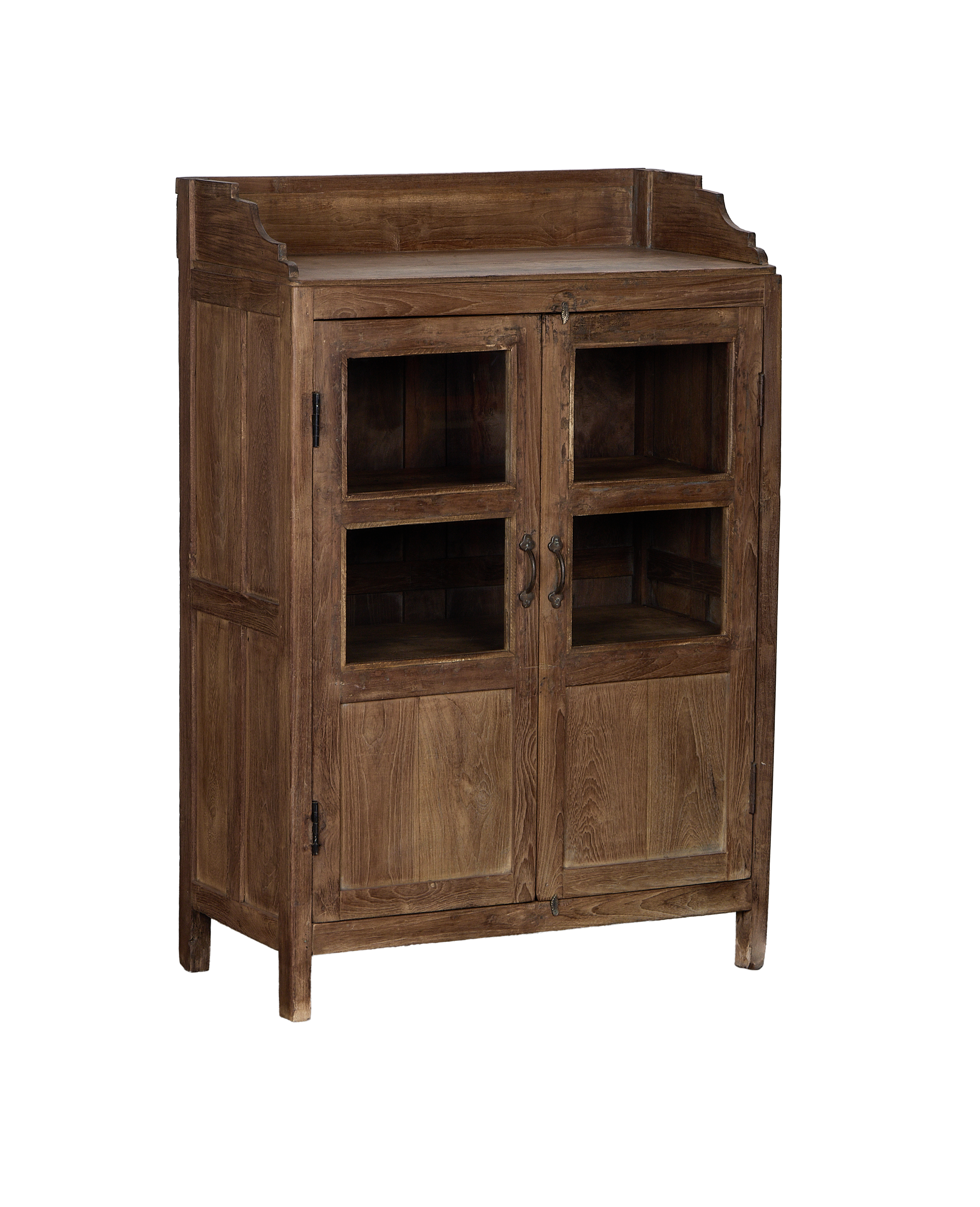 Angled view of vintage Indian oak wood cabinet, showing glass doors, brass pulls.