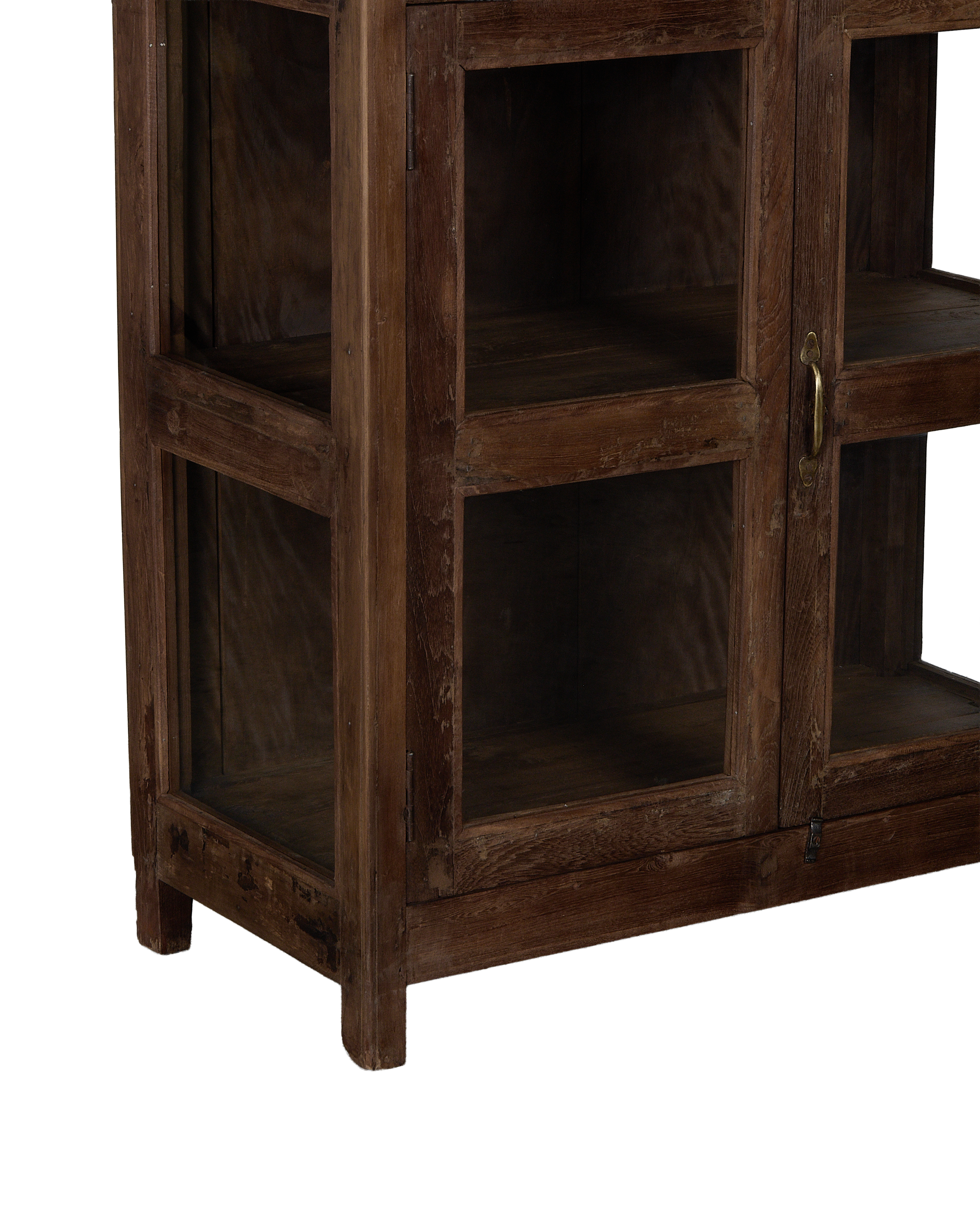 Vintage Indian oak wood cabinet, close-up of glass paneled door and bronze handle.